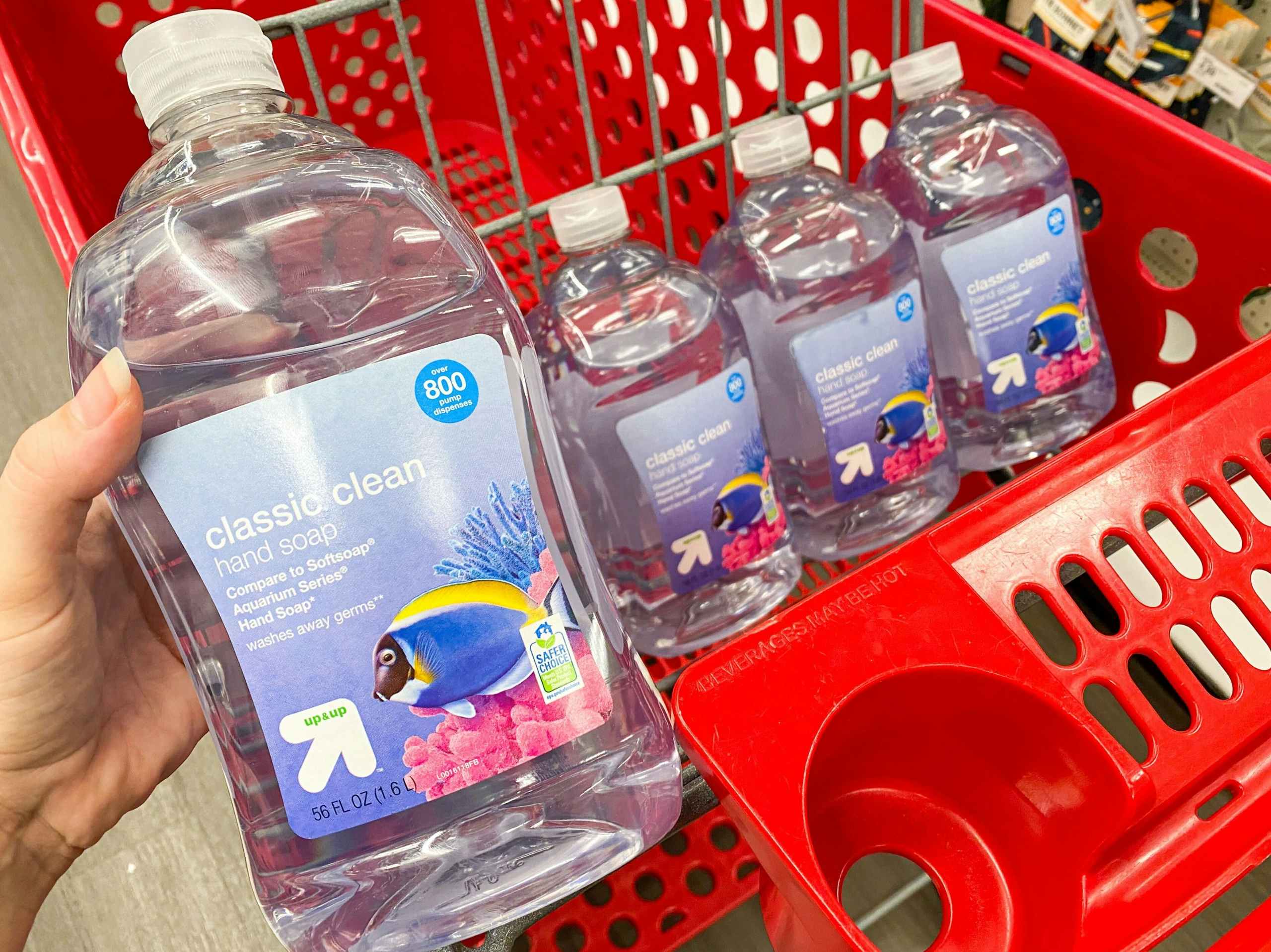 hand grabbing bottle of soap out of Target shopping cart
