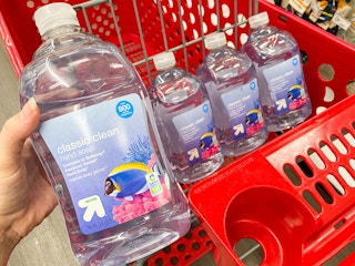 hand grabbing bottle of soap out of Target shopping cart