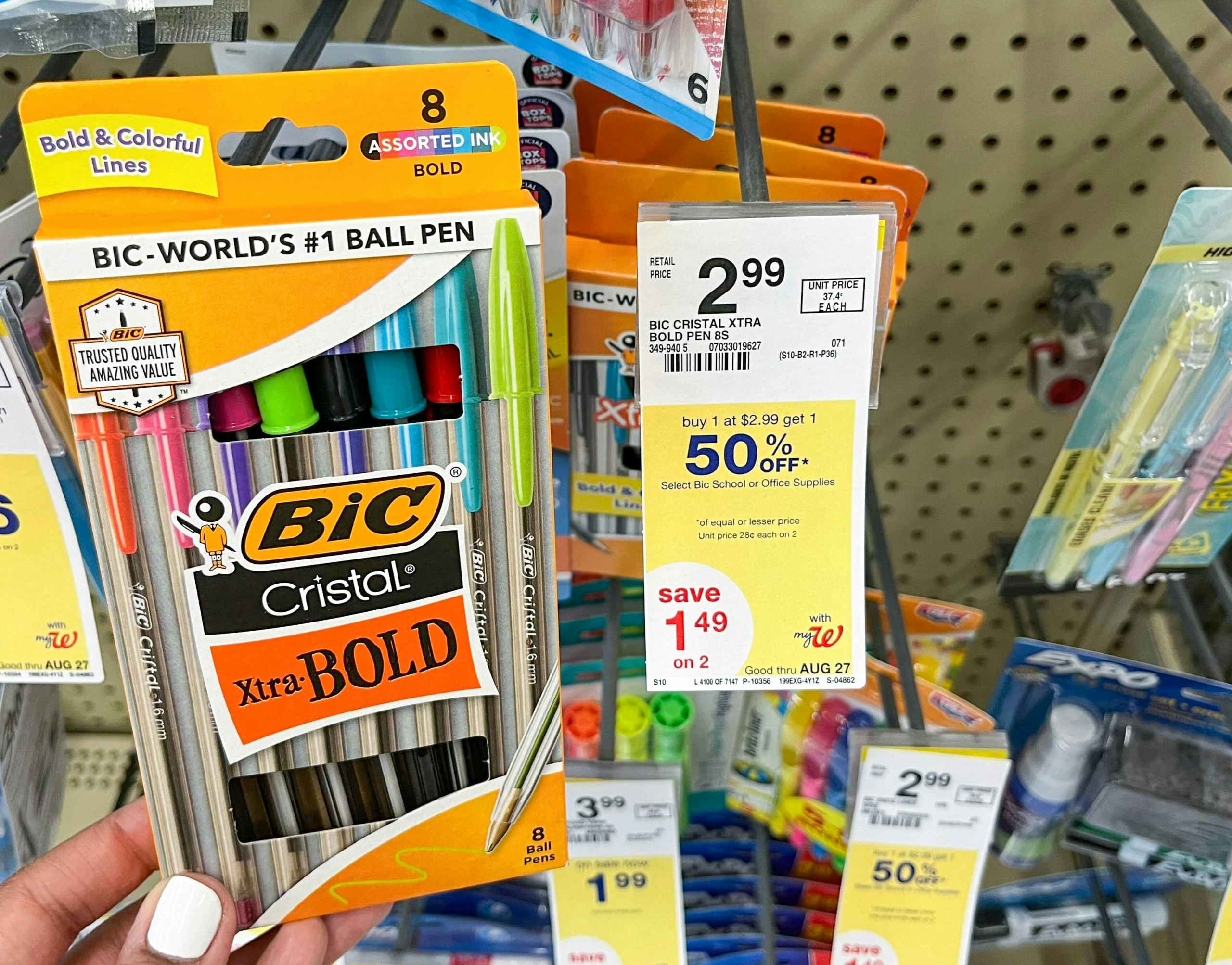 hand holding a box of BIC cristal pens next to sales tag