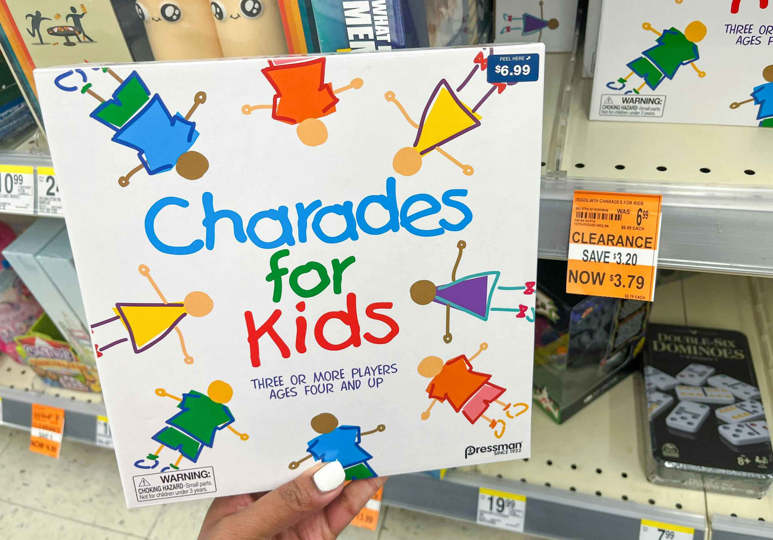 hand holding box of Charades for Kids next to clearance tag