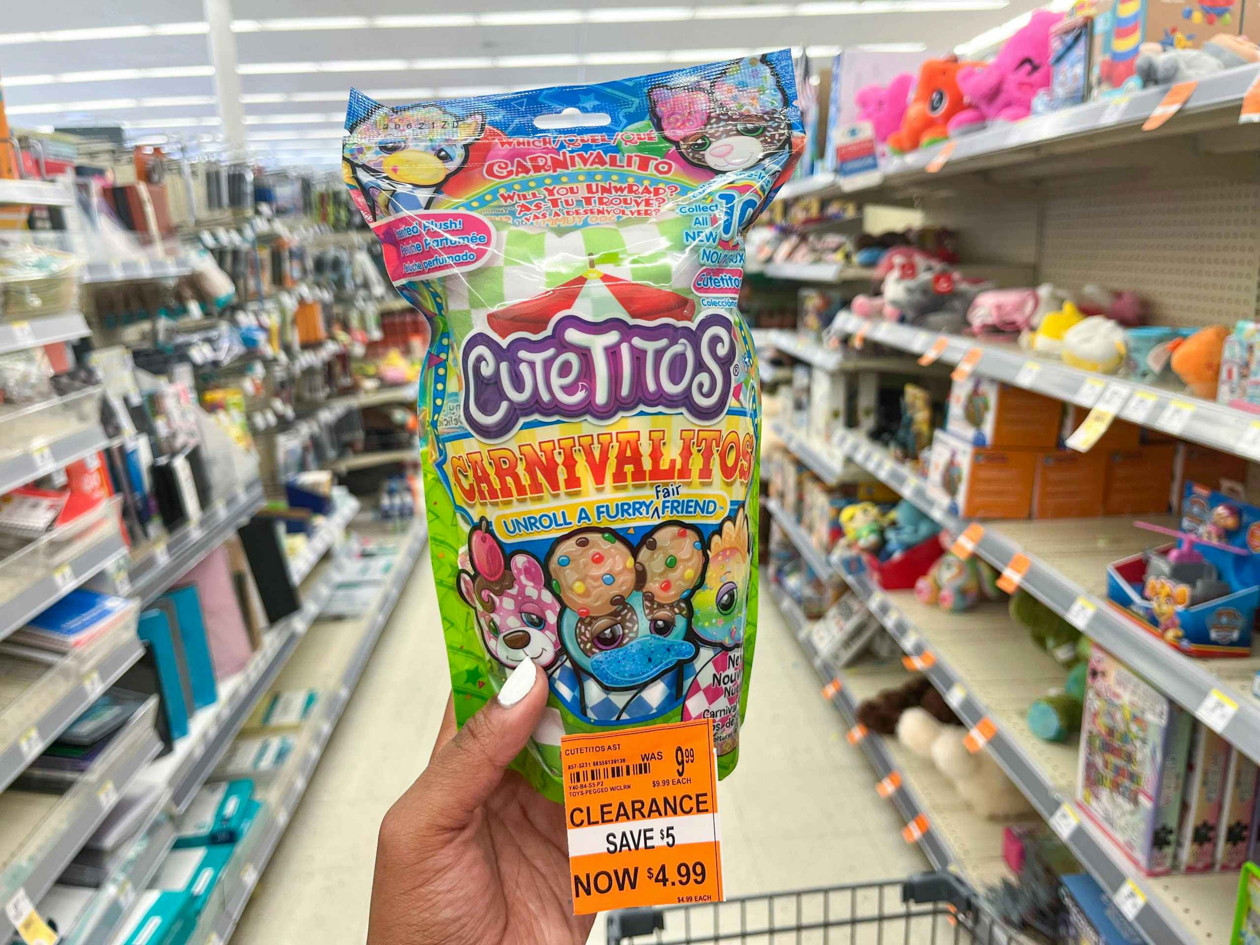 hand holding Cutetitos Carnivalitos toy in aisle with clearance tag attached to product