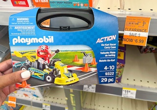 hand holding Playmobil carrying case next to clearance tag