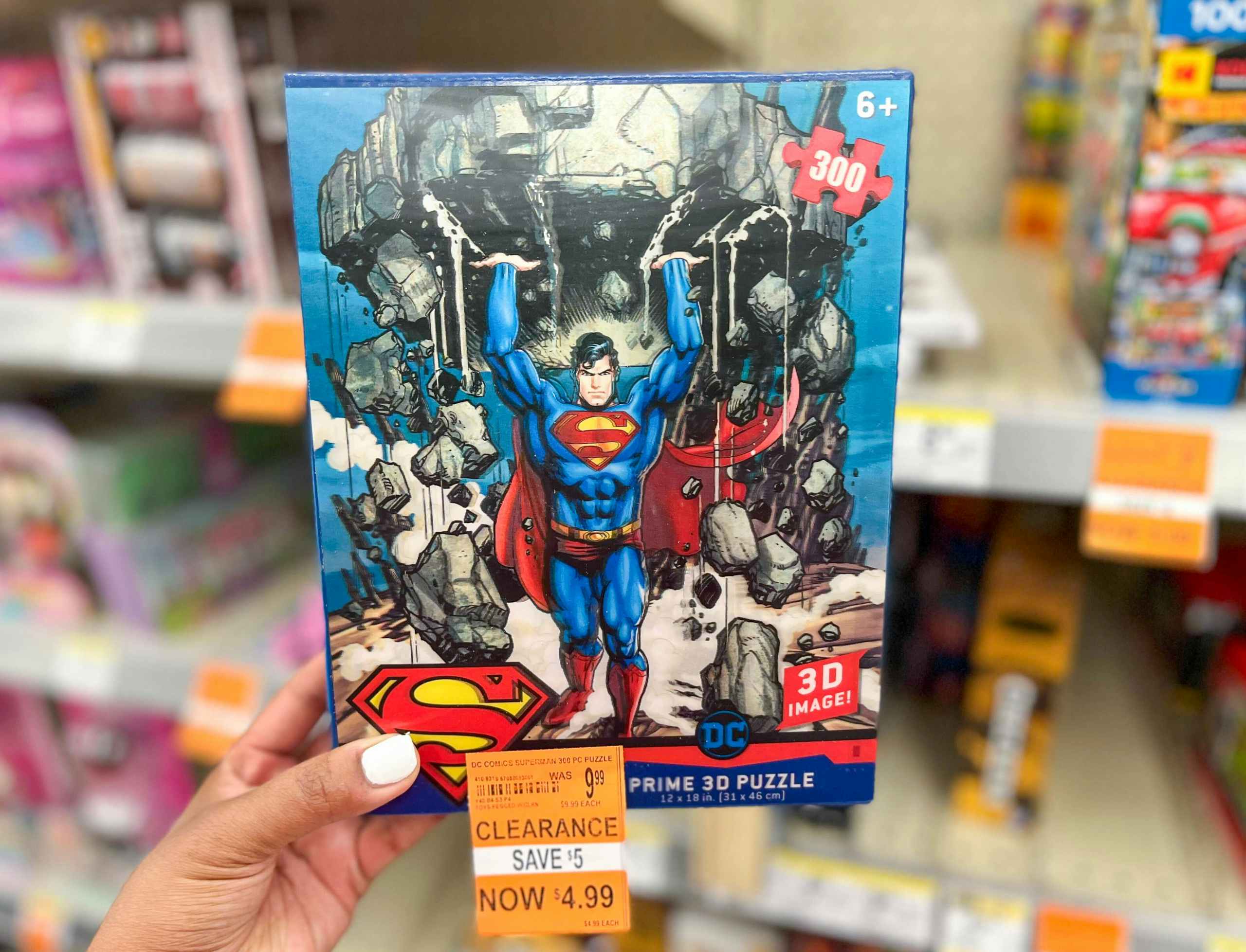 hand holding Superman 3D puzzle in aisle with clearance tag attached