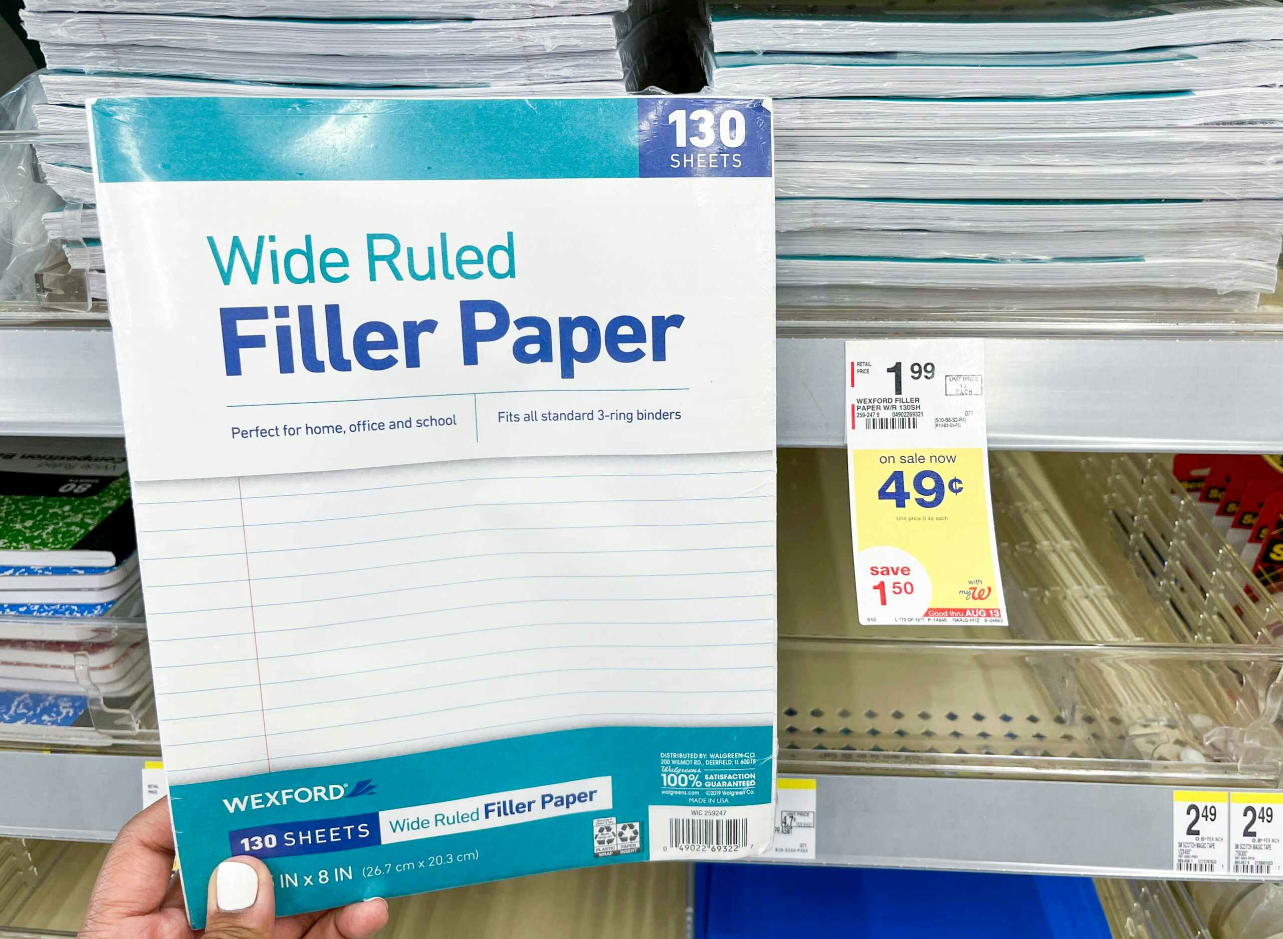 hand holding pack of Wexford Wide Ruled Filler Paper next to sales tag