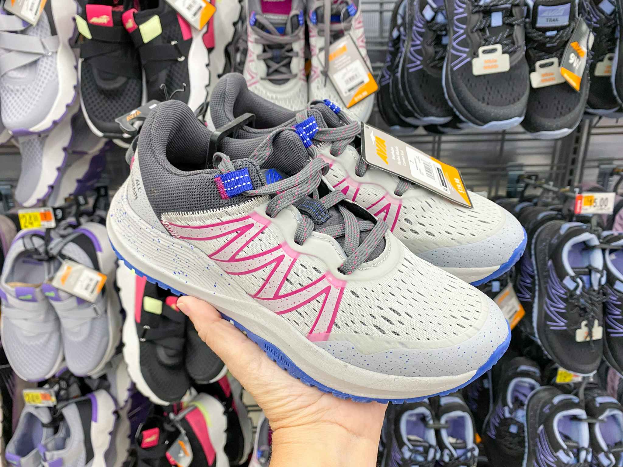 hand holding gray avia trail sneakers at walmart