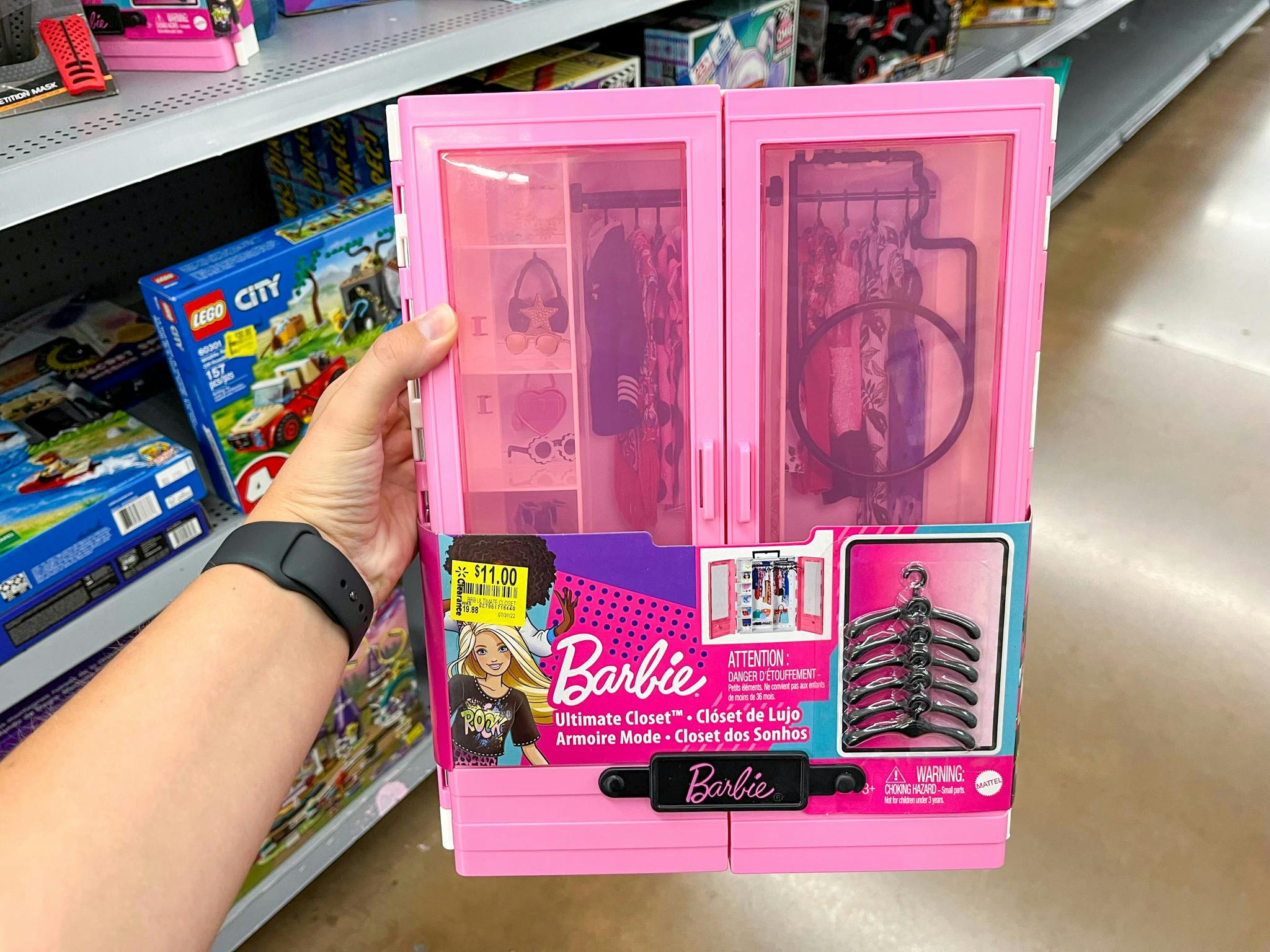 hand holding barbie ultimate closet at walmart