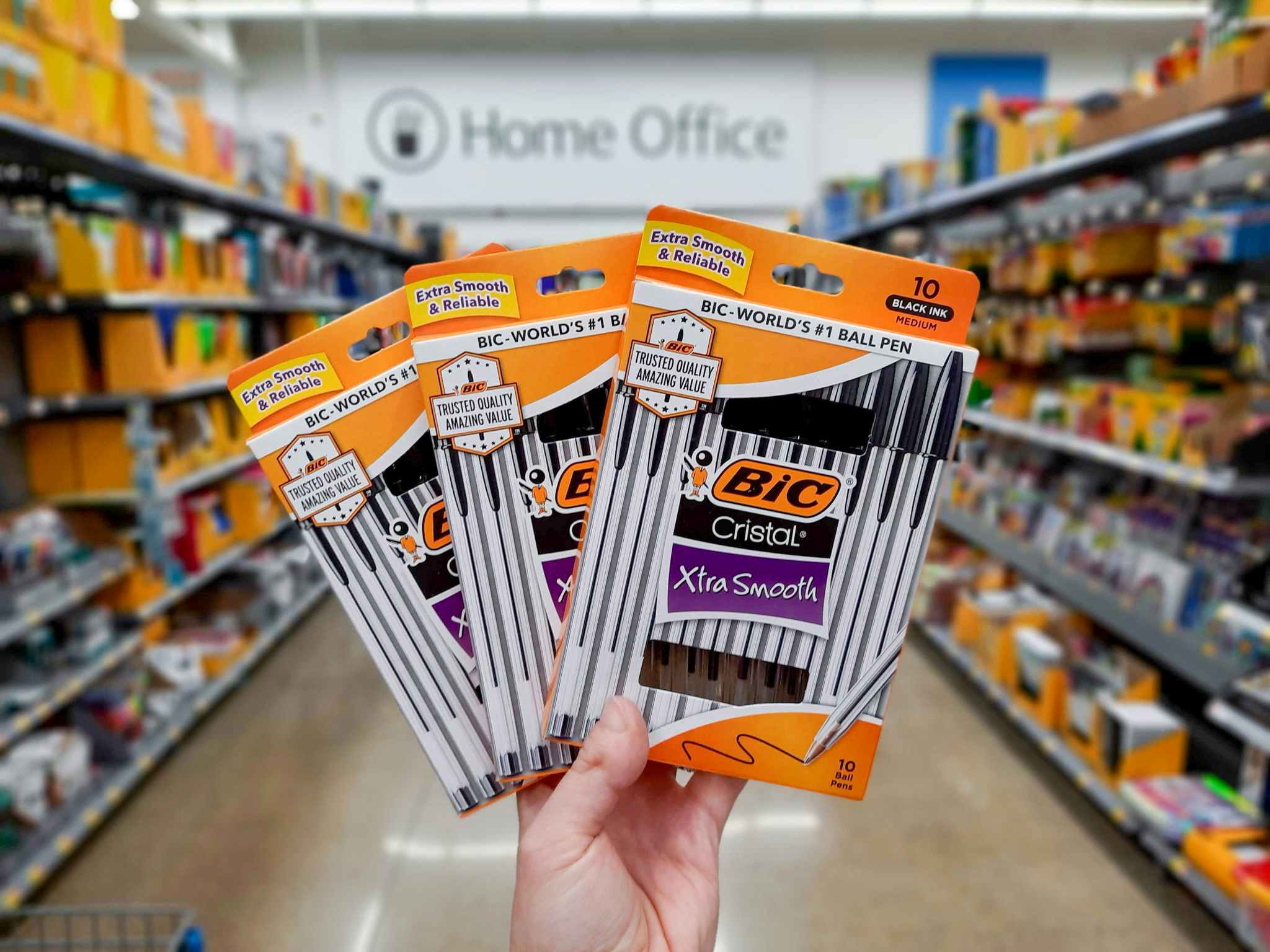 Three packages of BIC Cristal Pens held in home office supply aisle at Walmart