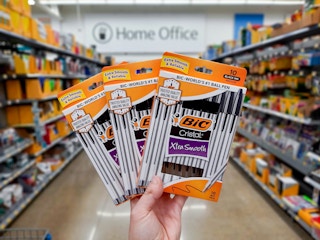 Three packages of BIC Cristal Pens held in home office supply aisle at Walmart