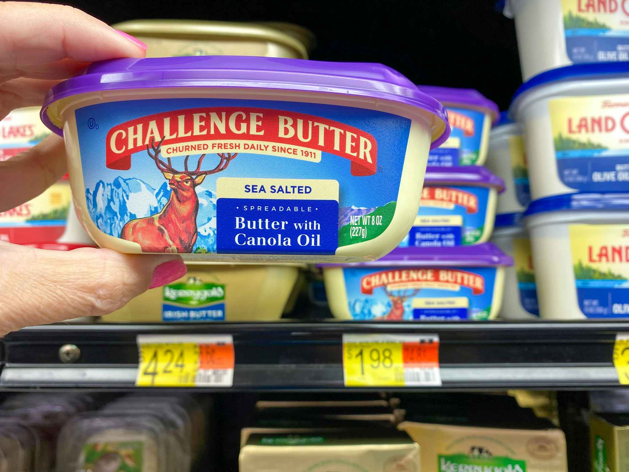 hand holding challenge butter at walmart