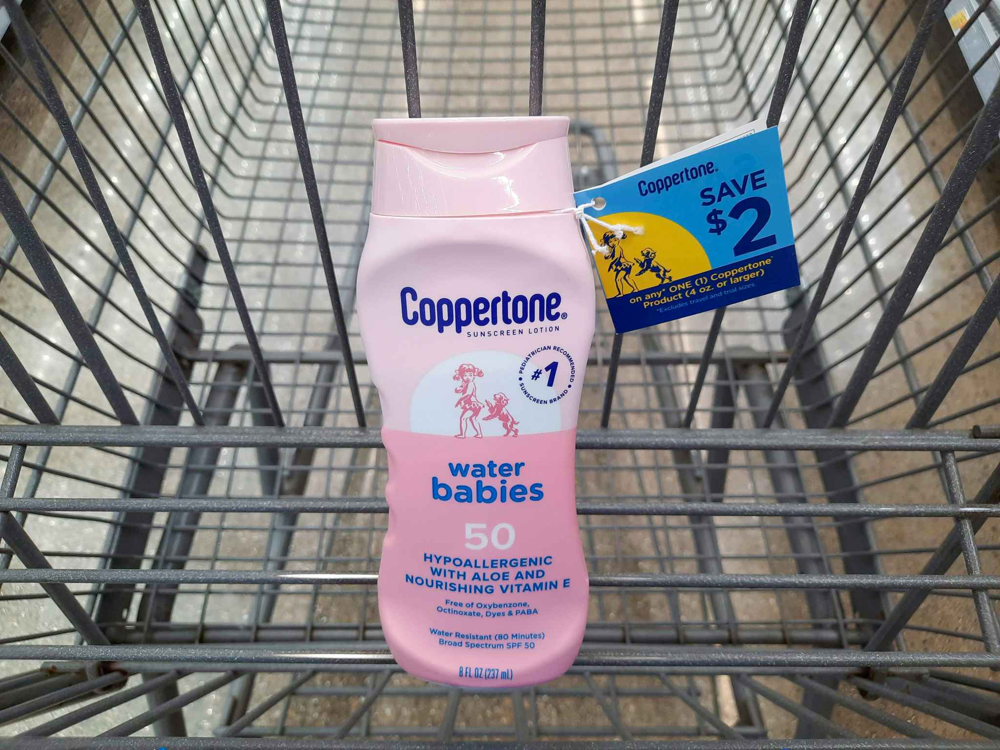 Coppertone Water Babies Sunscreen product in Walmart shopping cart. A $2 hangtag coupon is attached to the product.