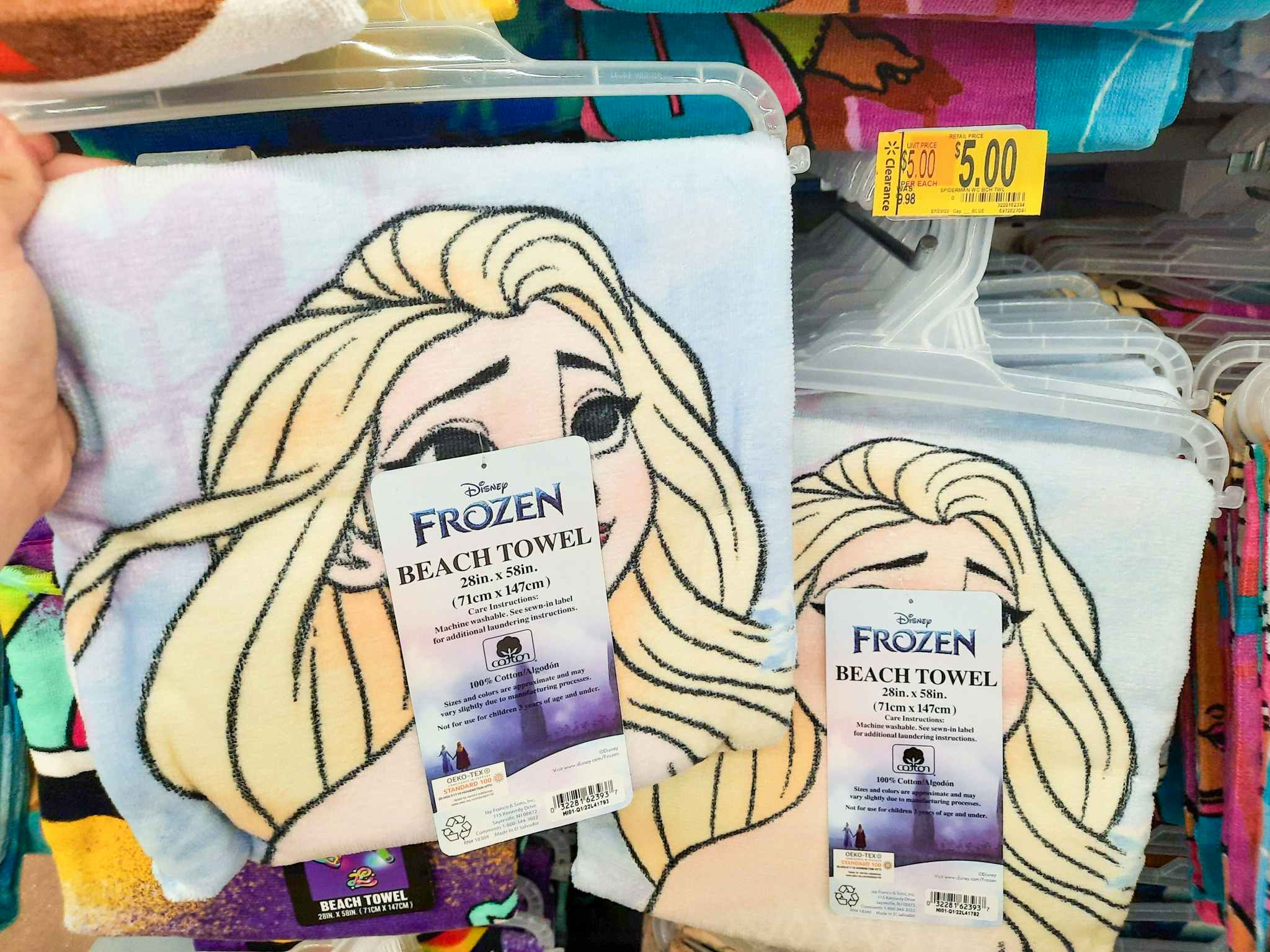 Disney Frozen Beach Towel held in front of $5 clearance tag.