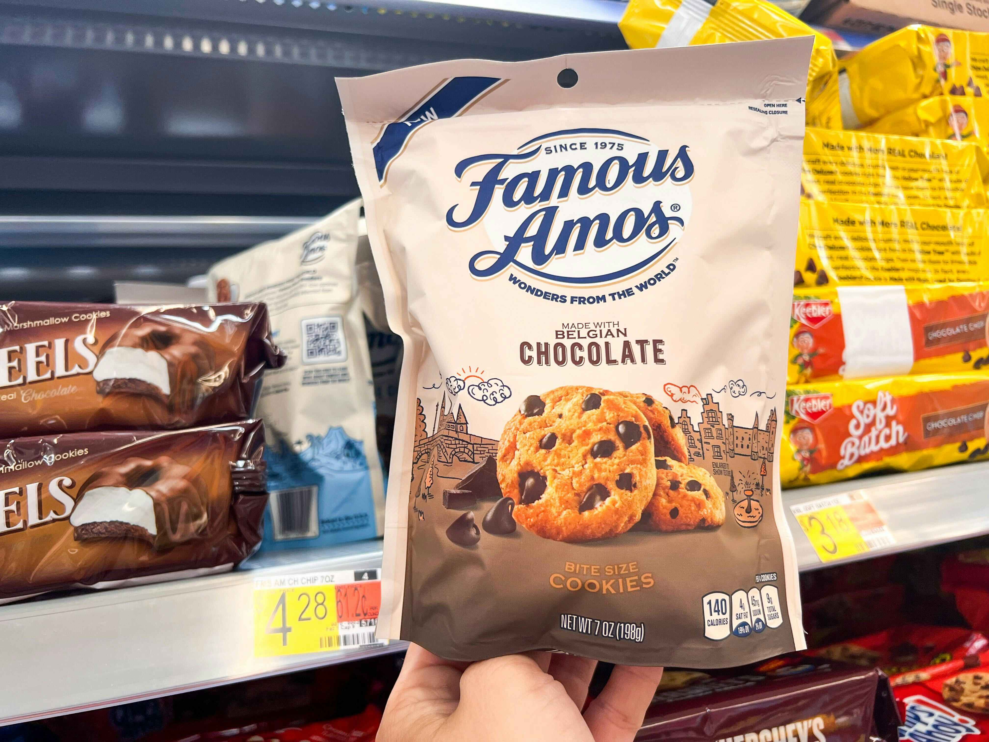 Hand holding a seven-ounce package of Famous Amos Cookies at Walmart