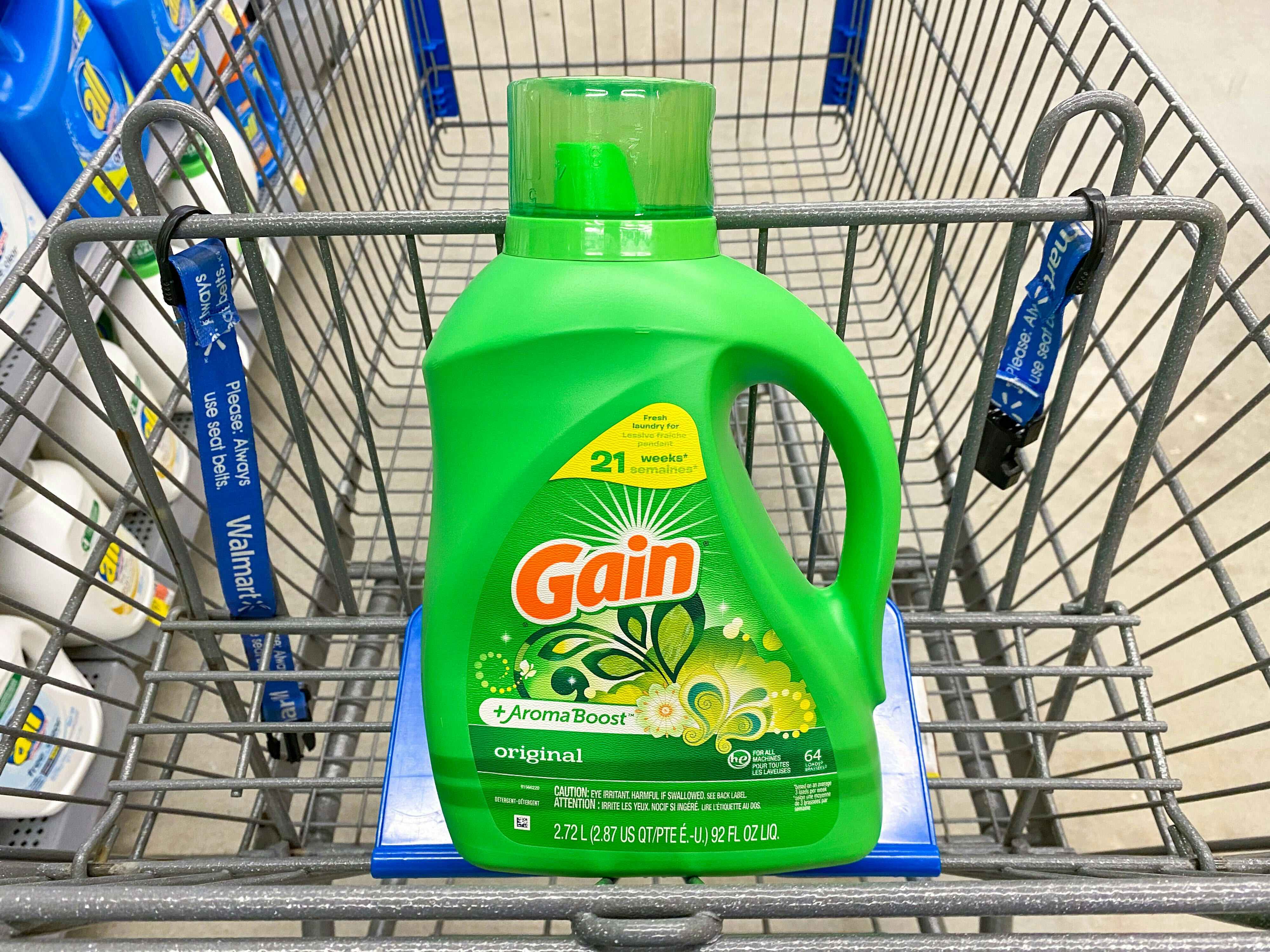 A bottle of Gain Liquid Laundry Detergent in a Walmart shopping cart