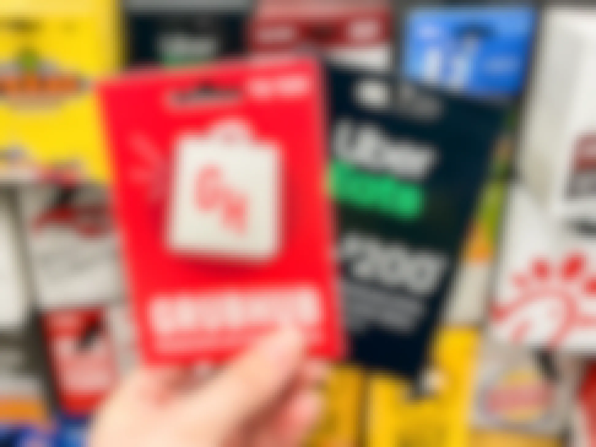 an image of a grubhub and uber eats gift card being held in front of gift card display