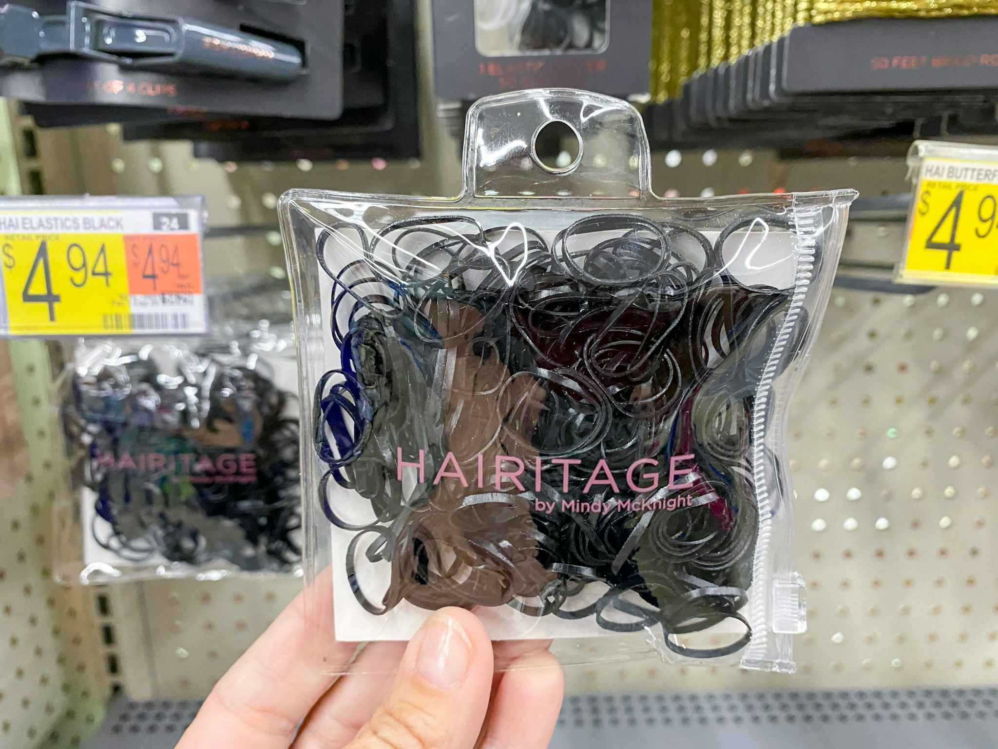 hand holding hairitage rubberbands at walmart
