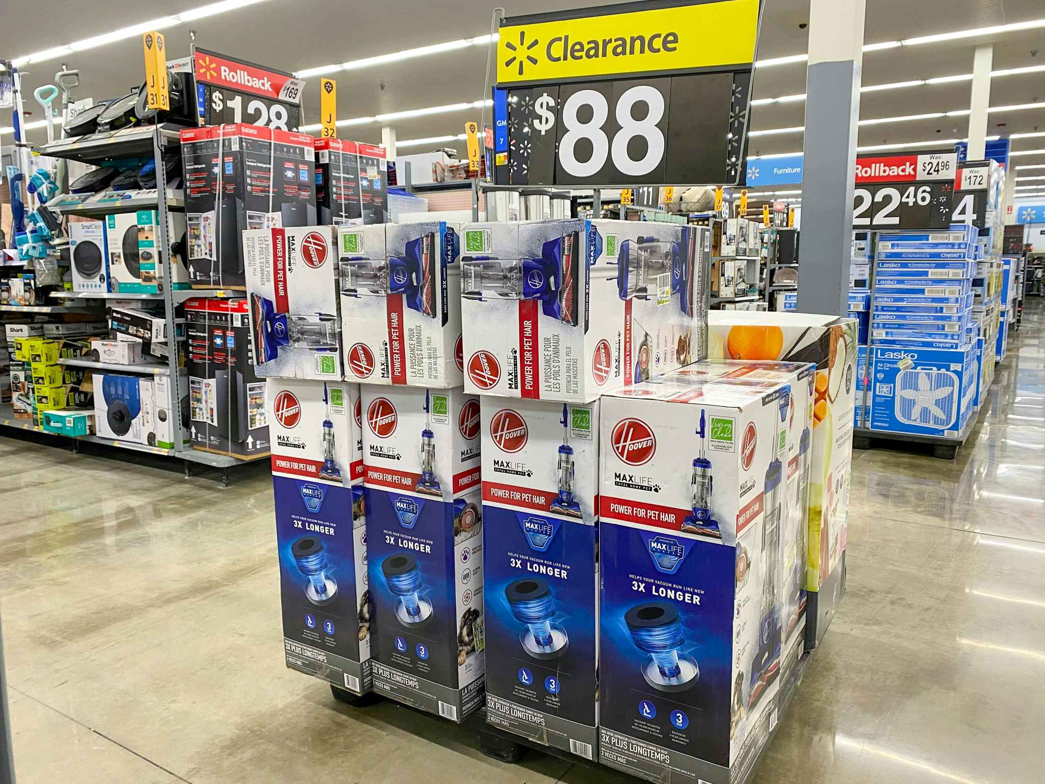 Hoover Total Home Pet Max Vacuum Cleaners on display at Walmart. Yellow clearance sign above display says $88.