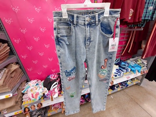 hand holding justice stranger things mom jeans at walmart