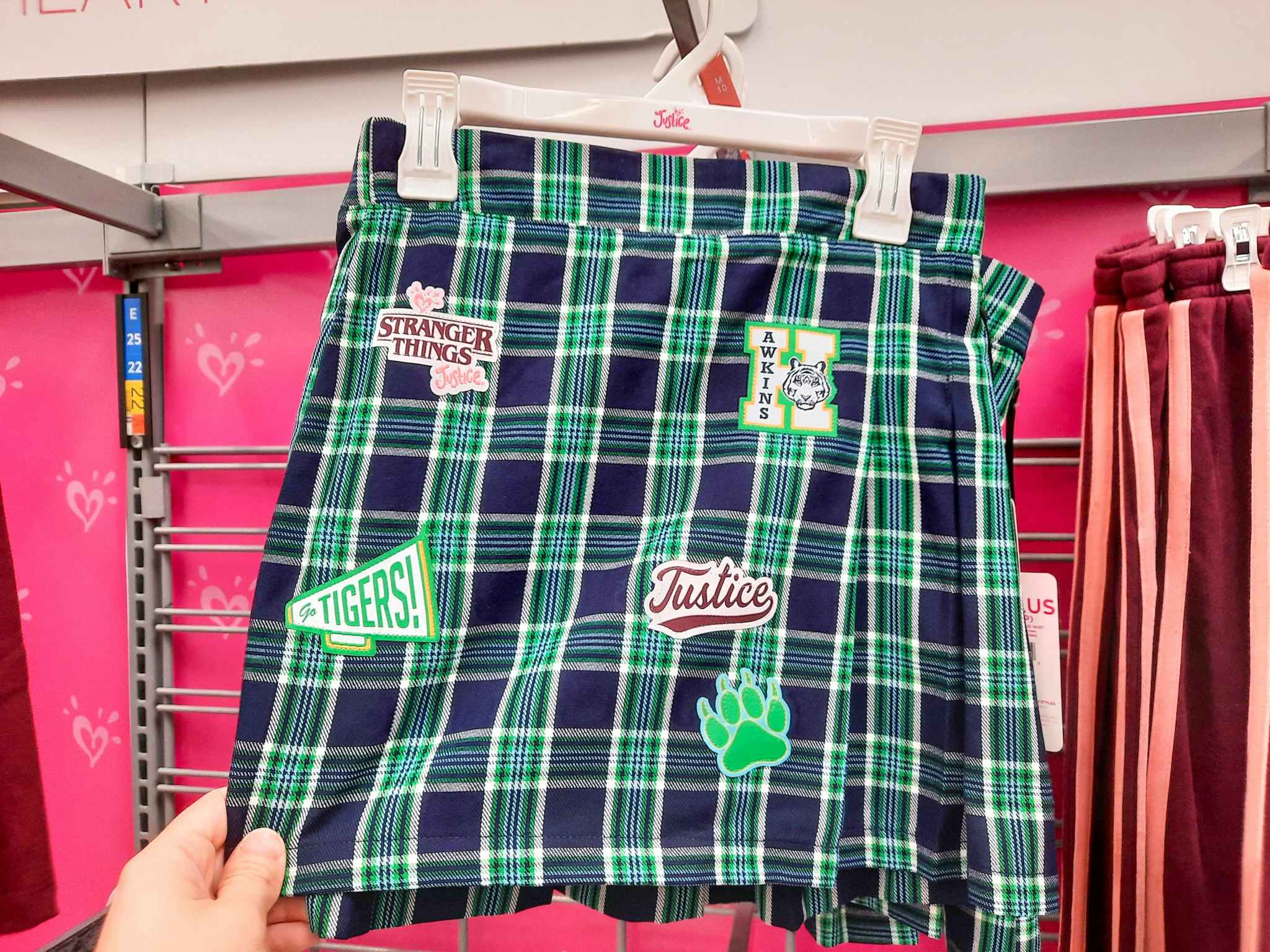 hand holding justice stranger things plaid skirt at walmart