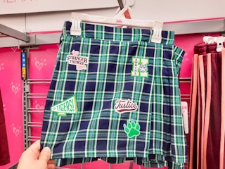 hand holding justice stranger things plaid skirt at walmart