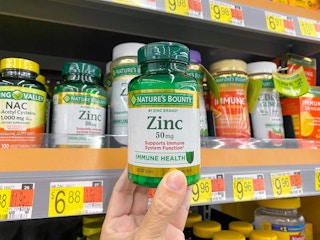 Nature's Bounty Zinc Immune Health product held in vitamins and supplements aisle at Walmart