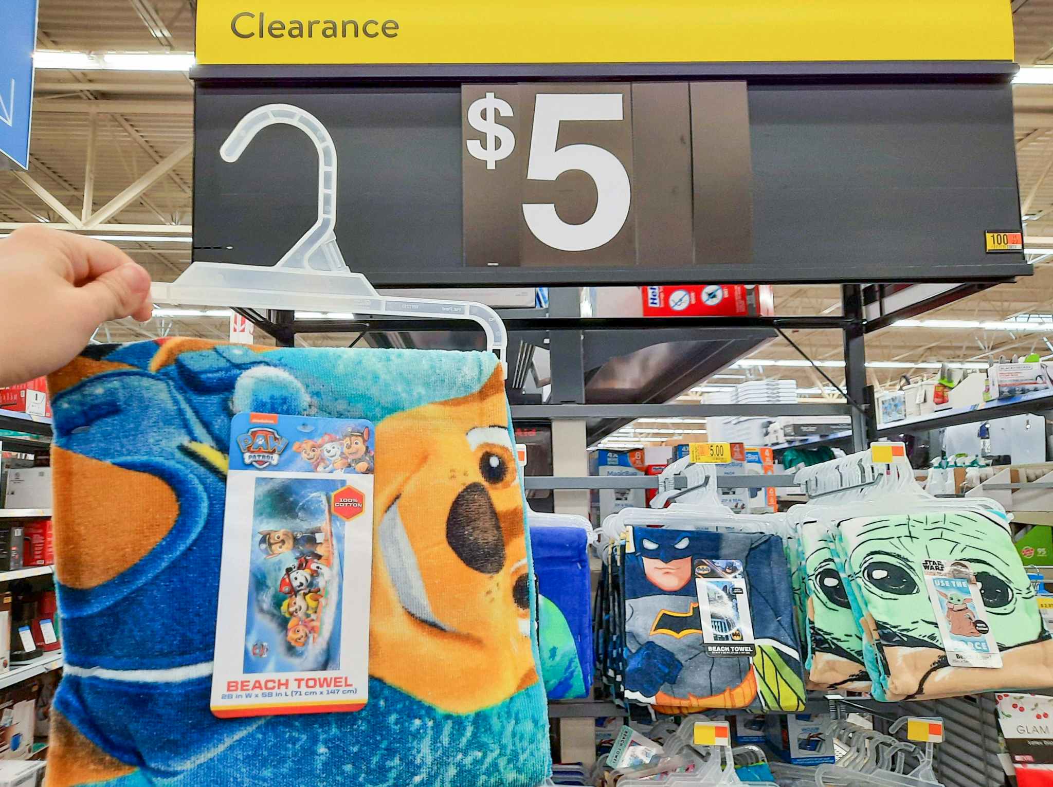 PAW Patrol Beach Towel held in front of $5 clearance sign.