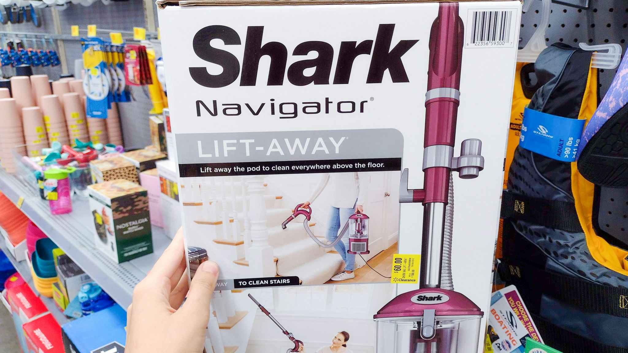 hand holding shark navigator lift away vacuum at walmart