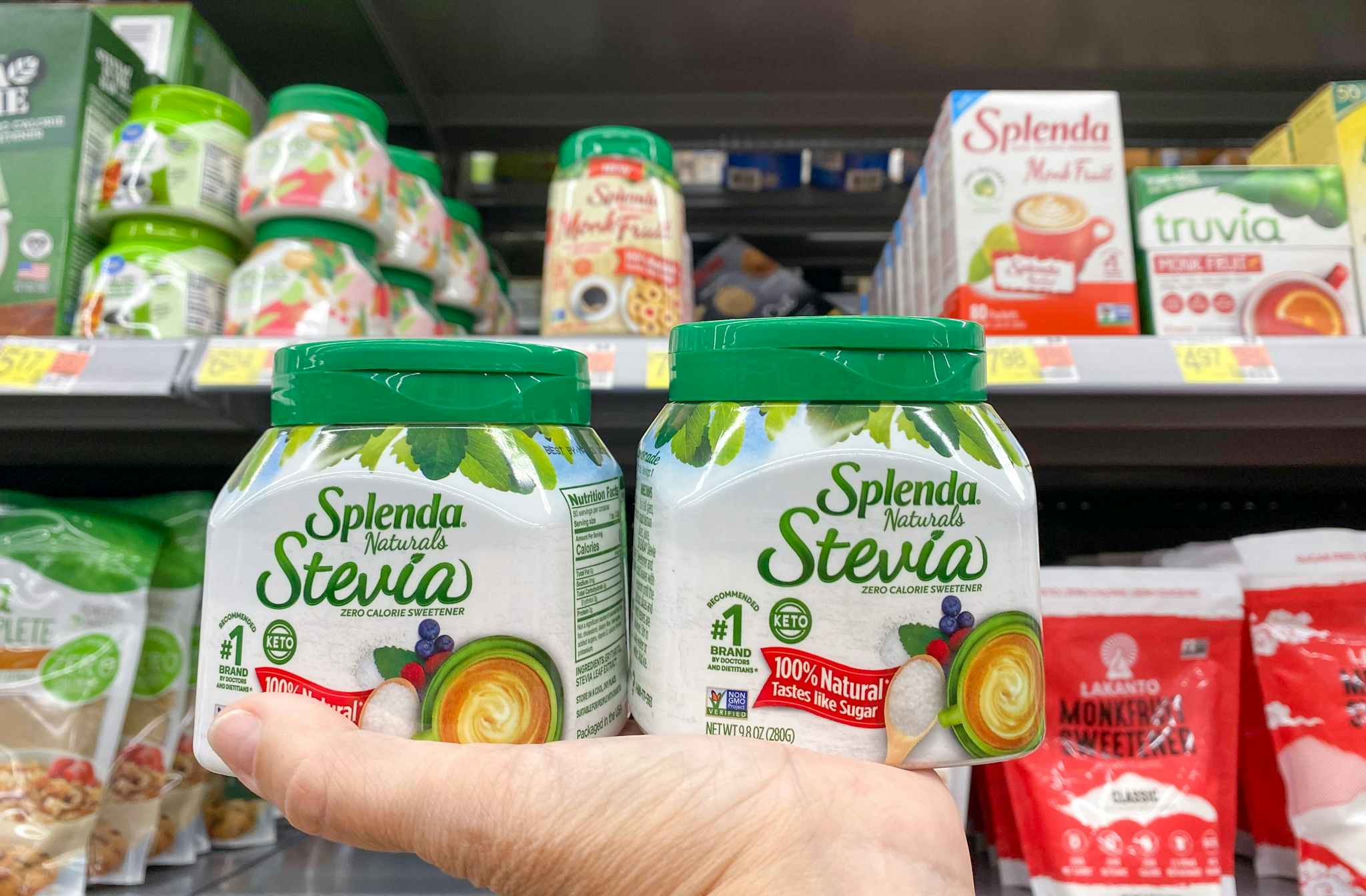 Two containers of Splenda Stevia held in hand at Walmart