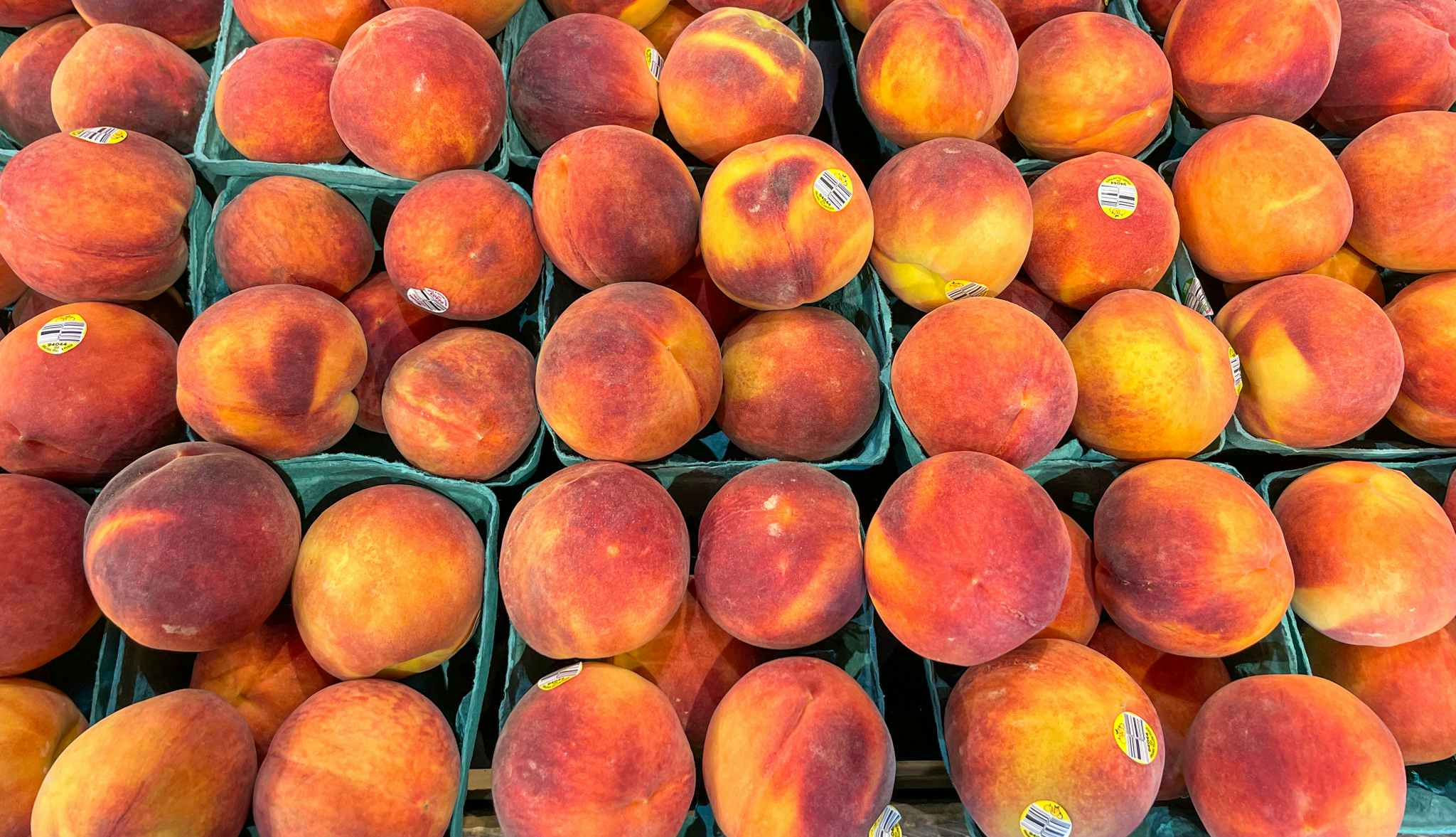 peaches on a shelf at whole foods