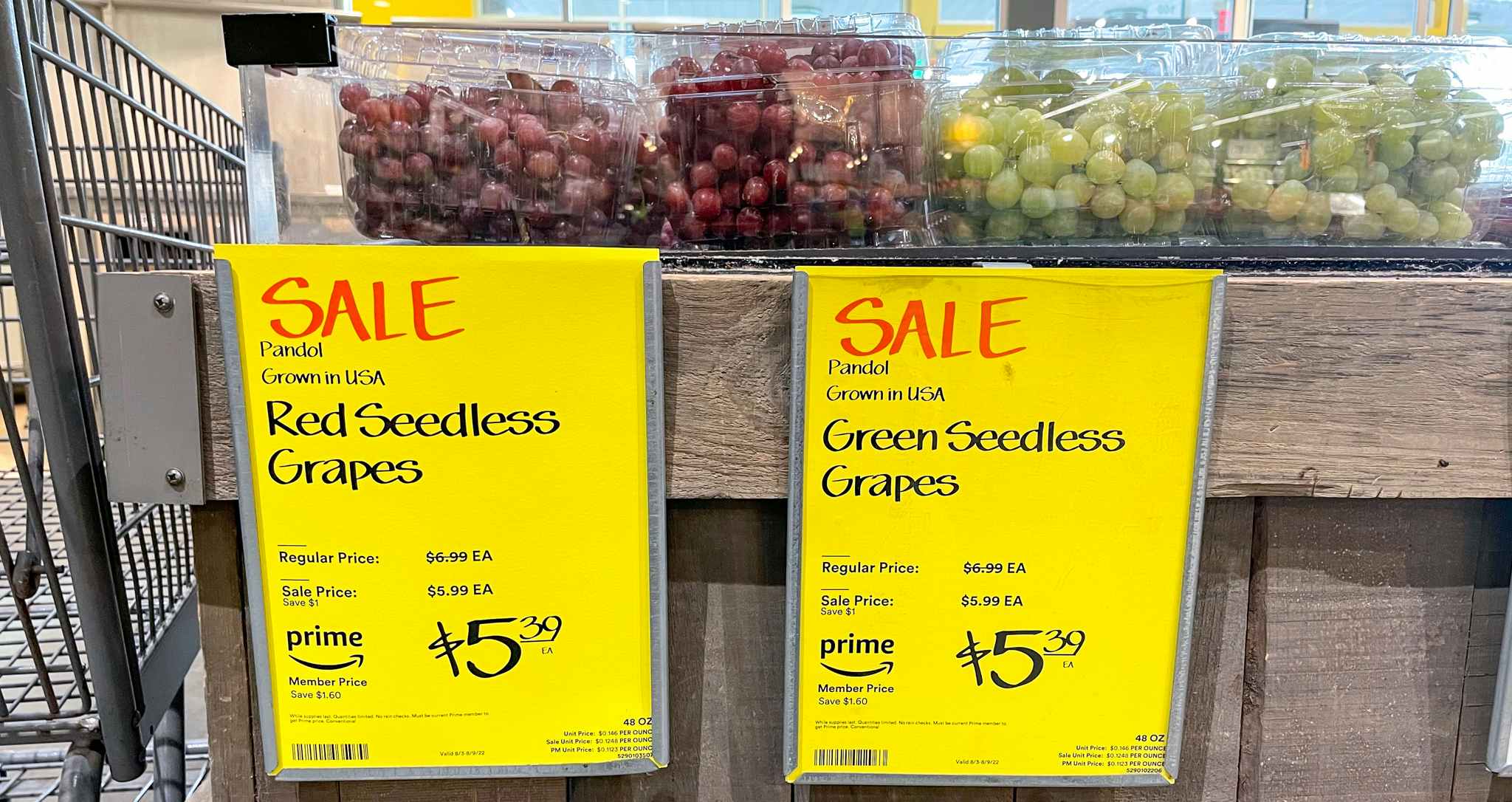 packaged grapes with sales sign at whole foods