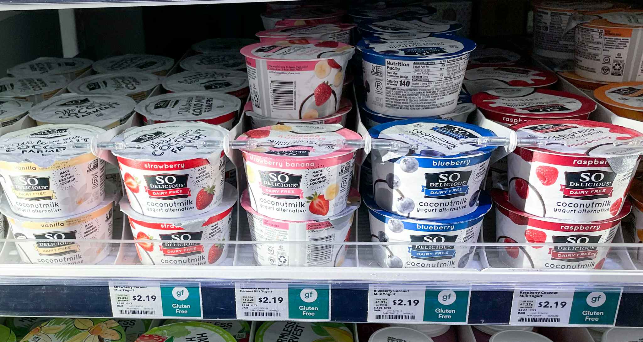 yogurts on shelf with sales sign at whole foods