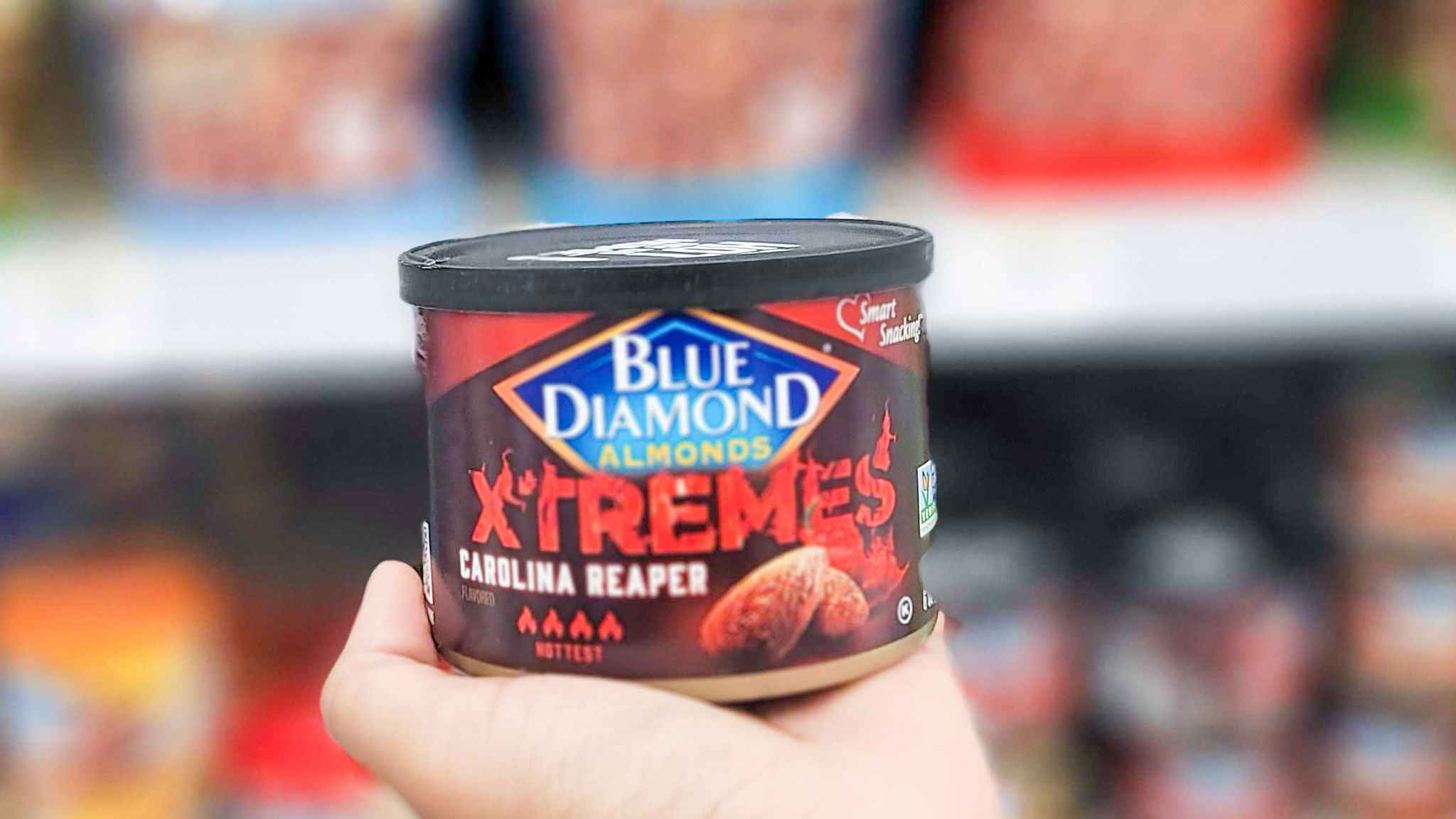 hand holding can of blue diamond almonds