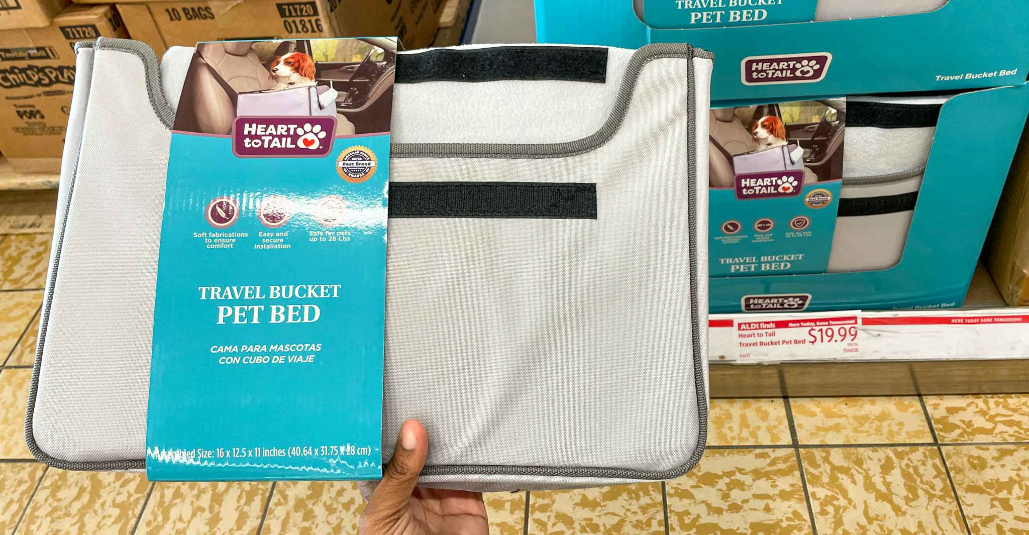 pet bed hand held near sale sign at aldi