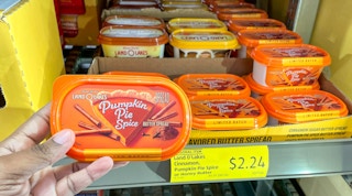 butter hand held near sale sign at aldi