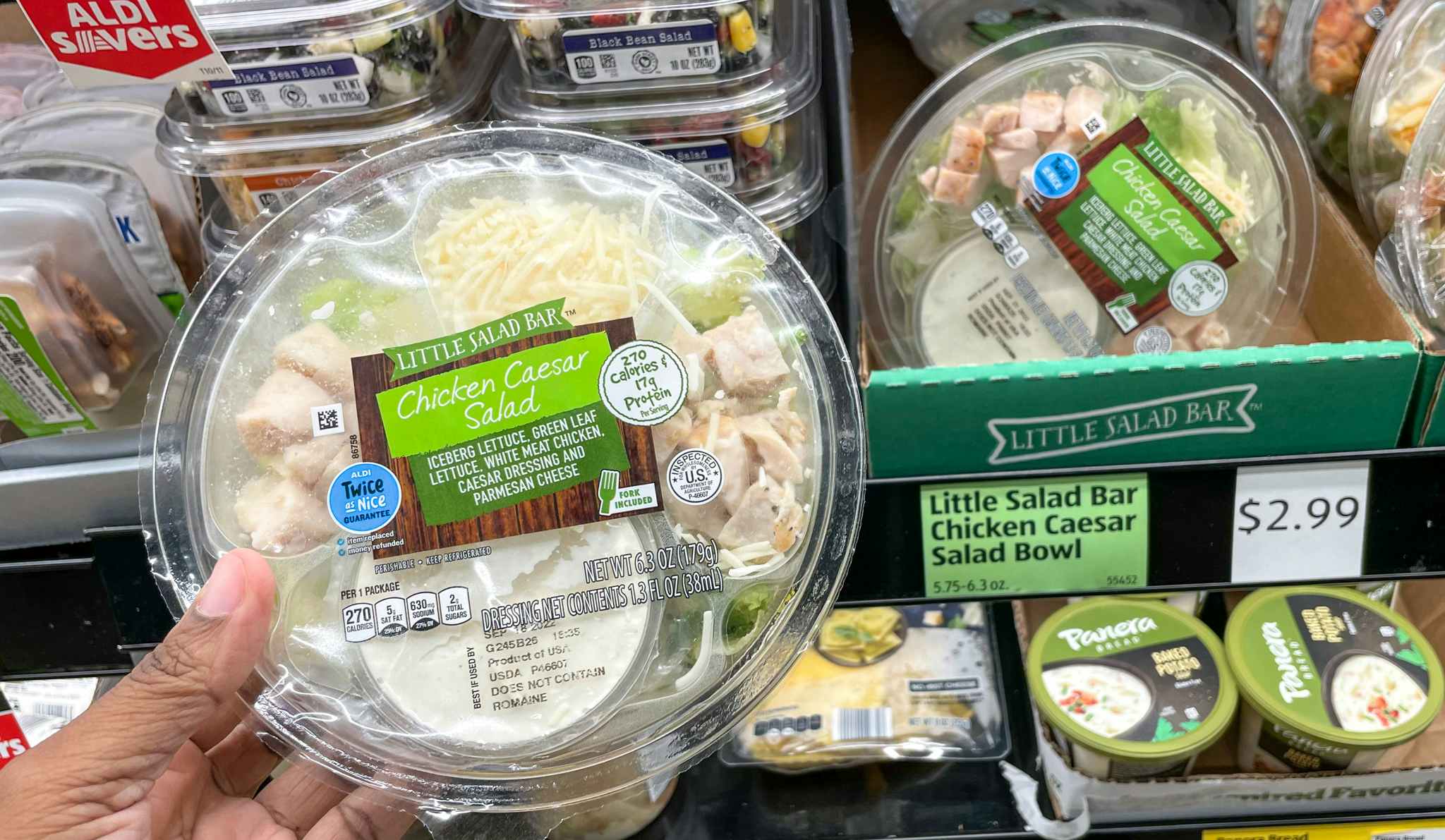 salad bowl hand held near sale sign at aldi