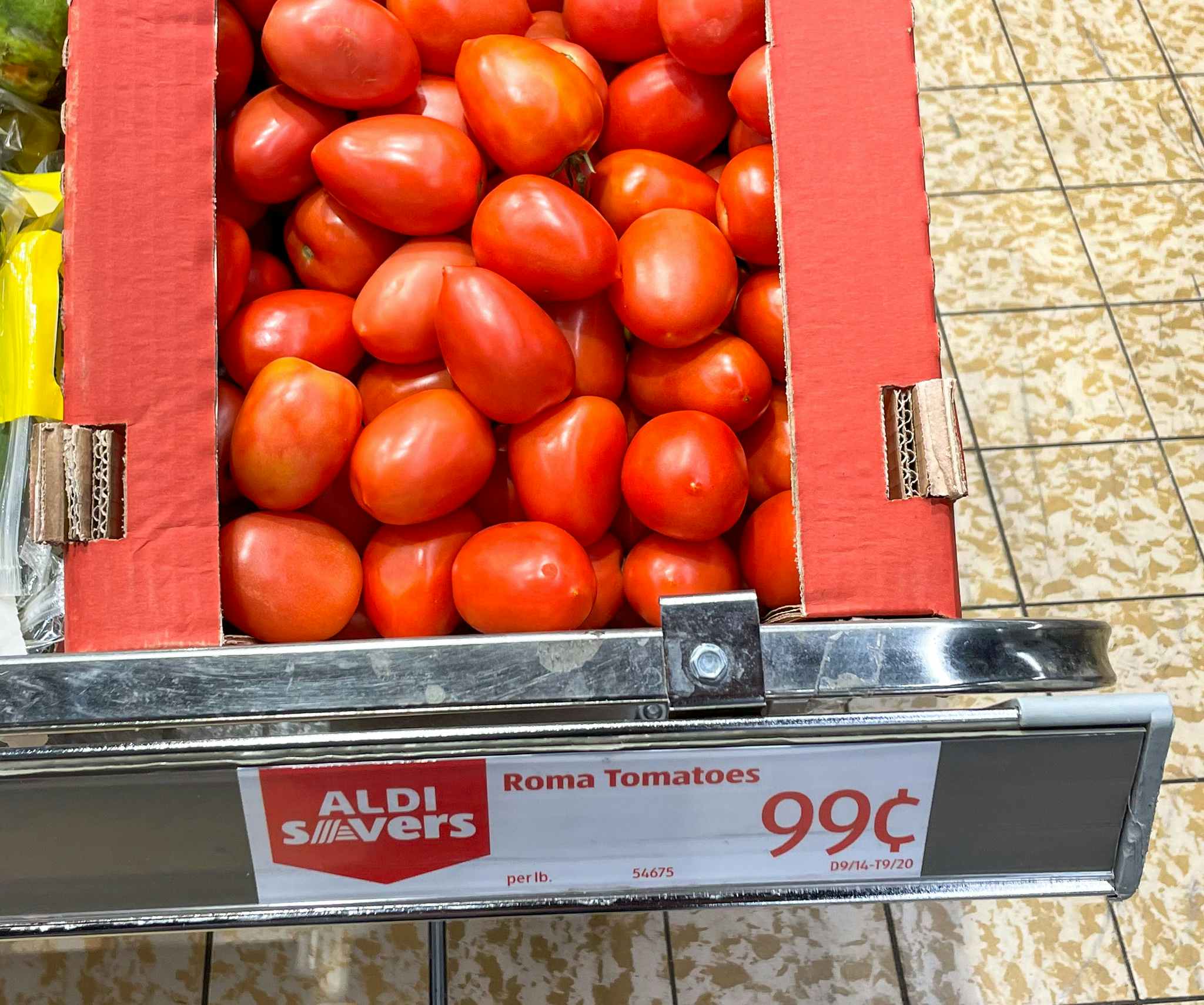 roma tomatoes in a box with sale sign at aldi