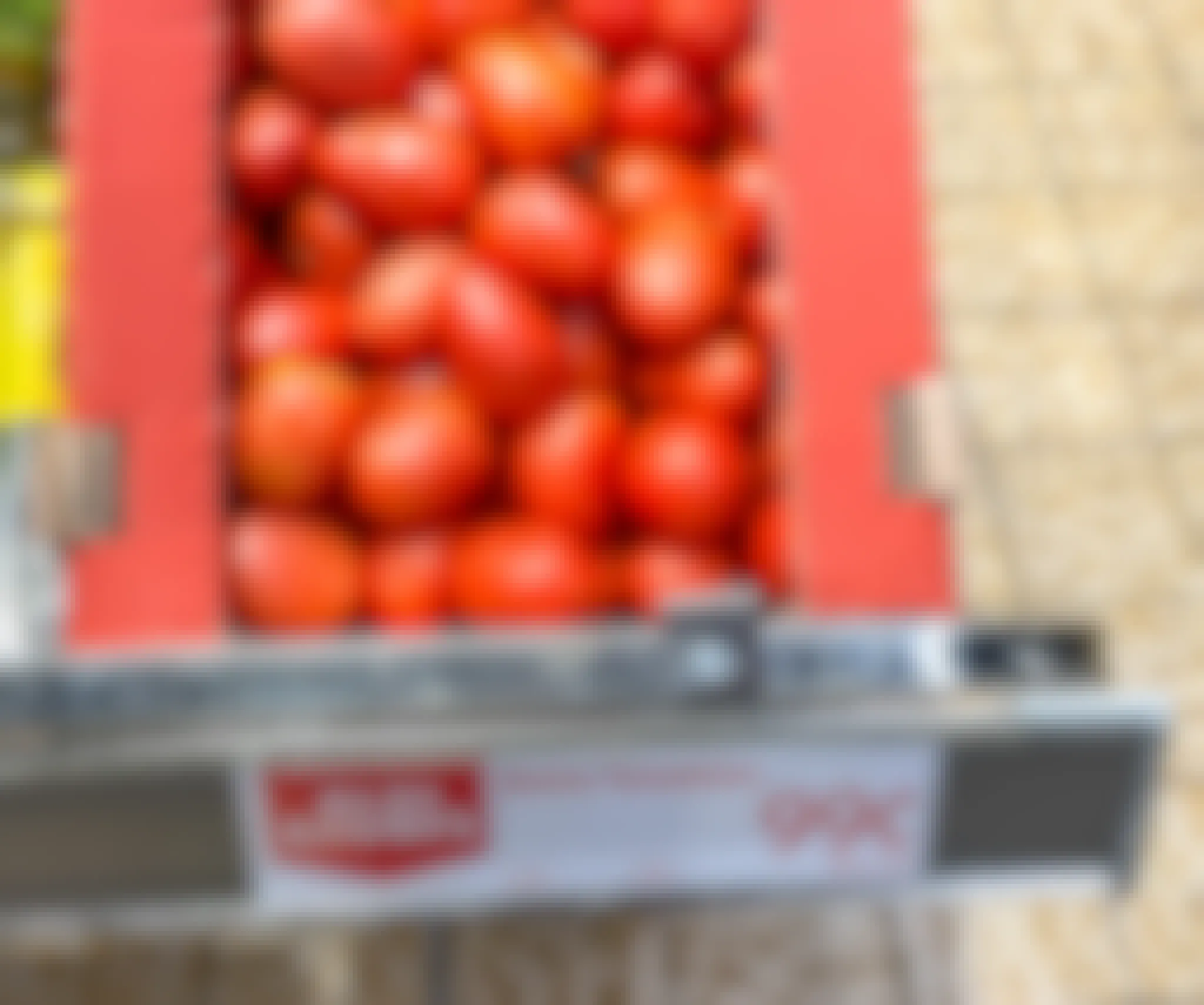 roma tomatoes in a box with sale sign at aldi