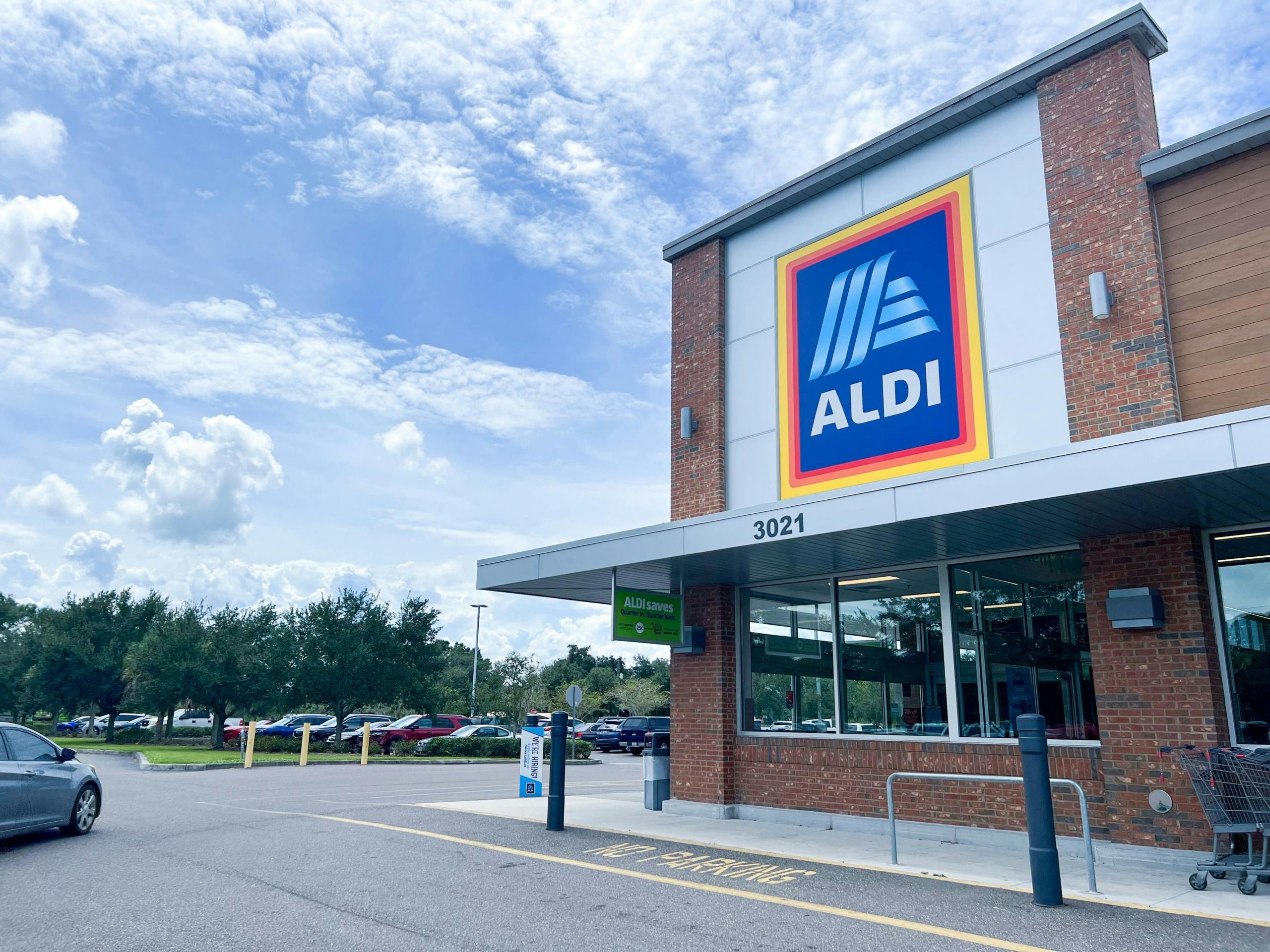 Aldi storefront with car driving by