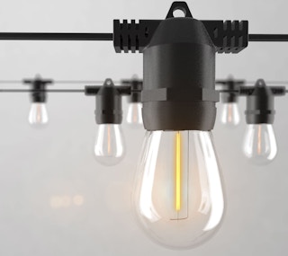 Outdoor string lights on a grey background.