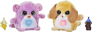 Two FurReal Fuzzalot stuffed animals with a feeding toy.