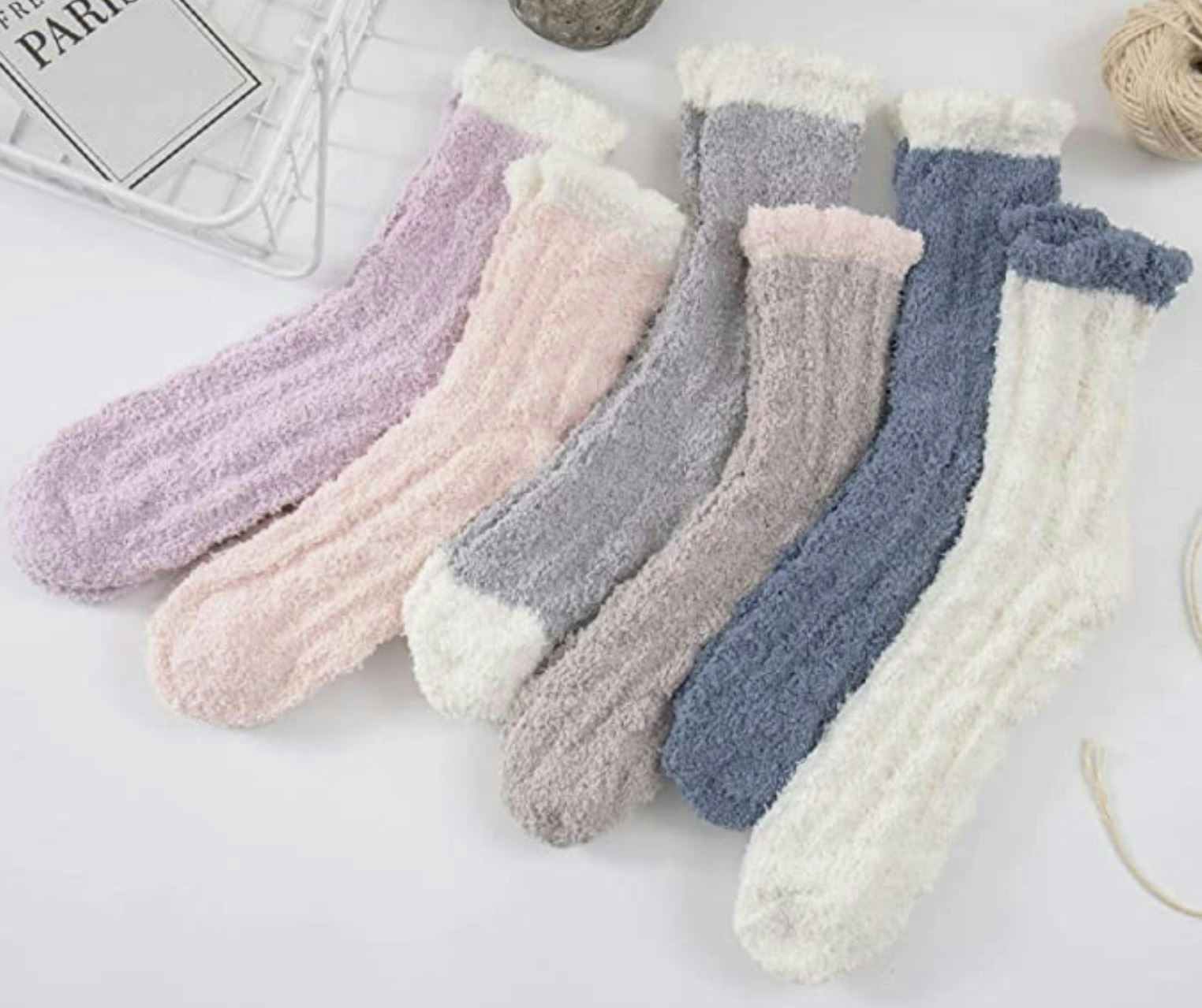 A pair of six fuzzy socks on a table.