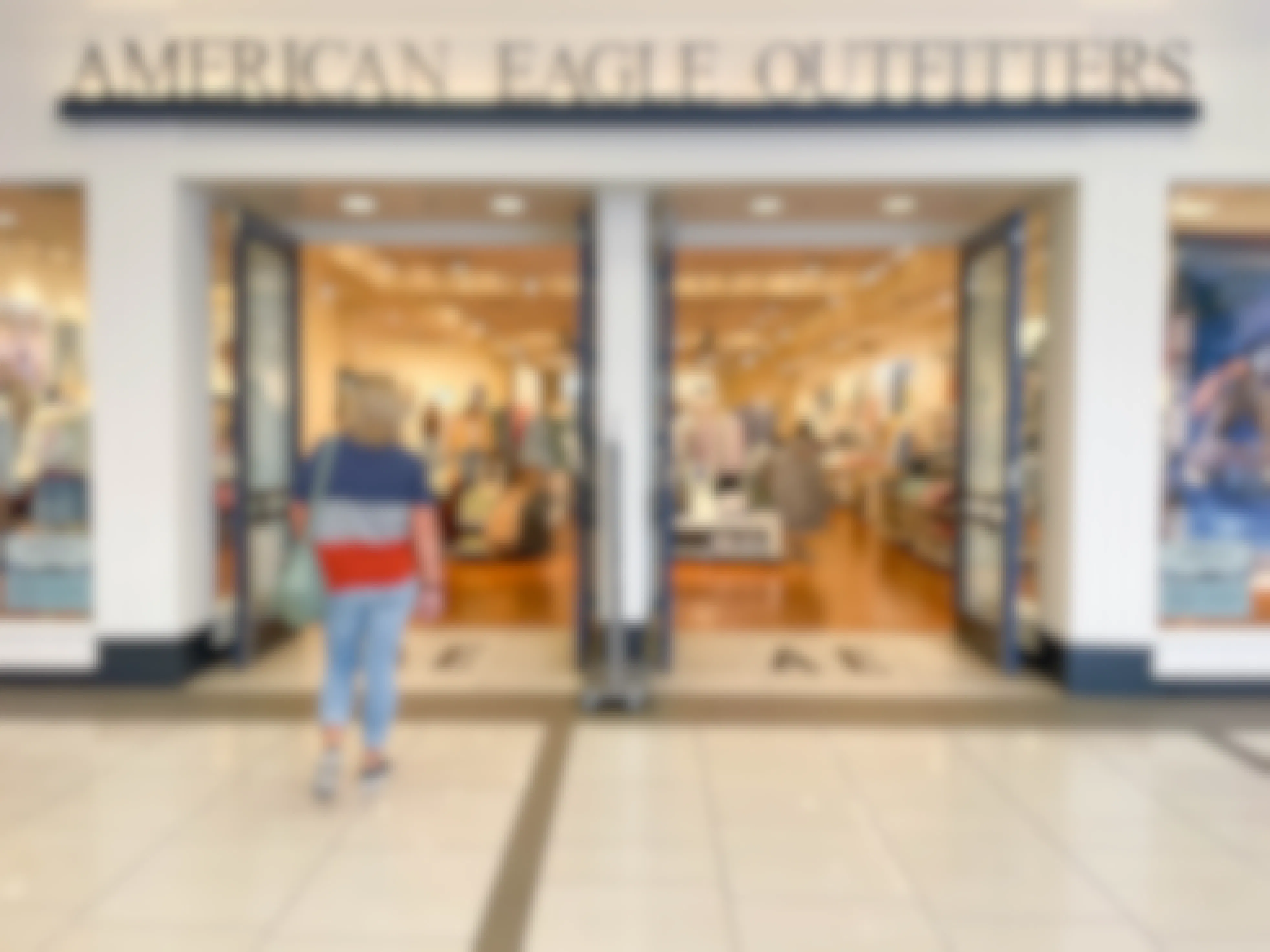 woman walking into american eagle store in mall