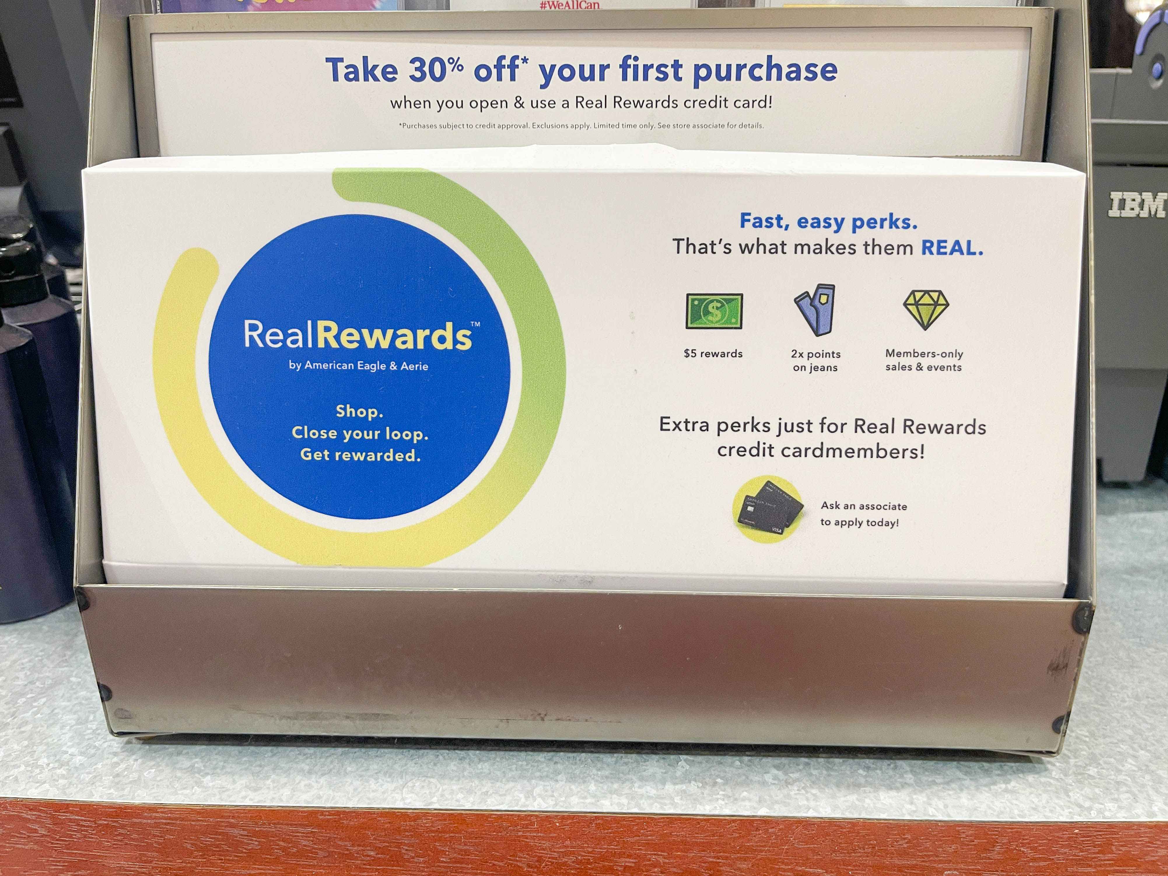 A sign for Real Rewards at the counter in an American Eagle store