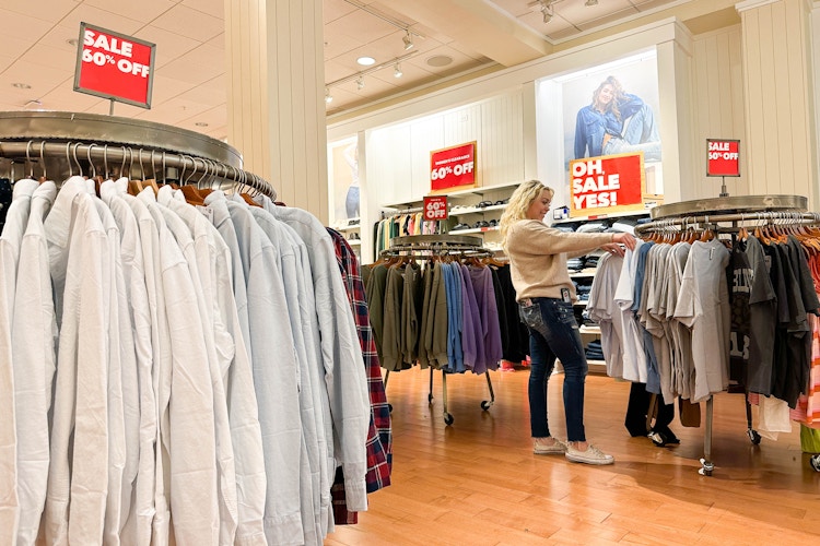 a woman looking at a sales items in america eagle
