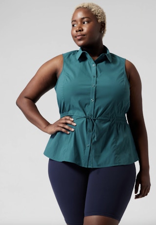 a woman waring a teal atheta tank