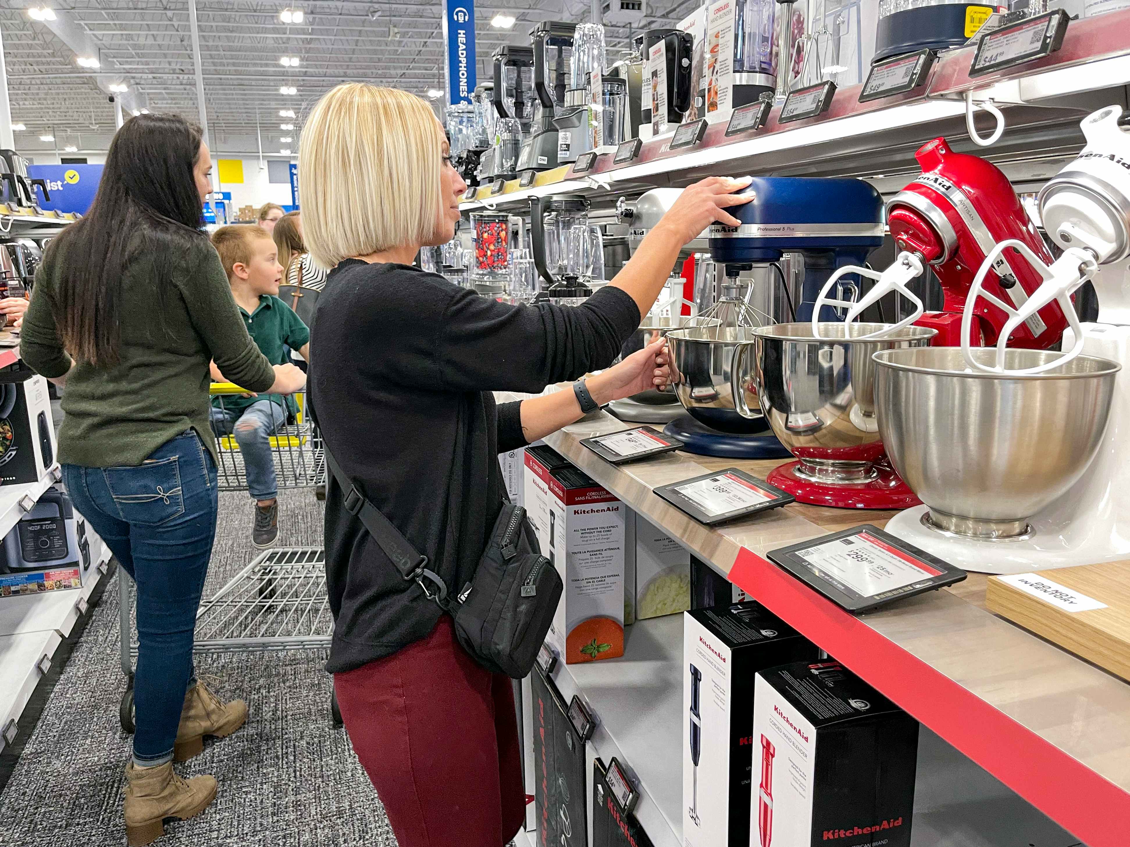 A woman looking at KitchenAid mixers at Best Buy