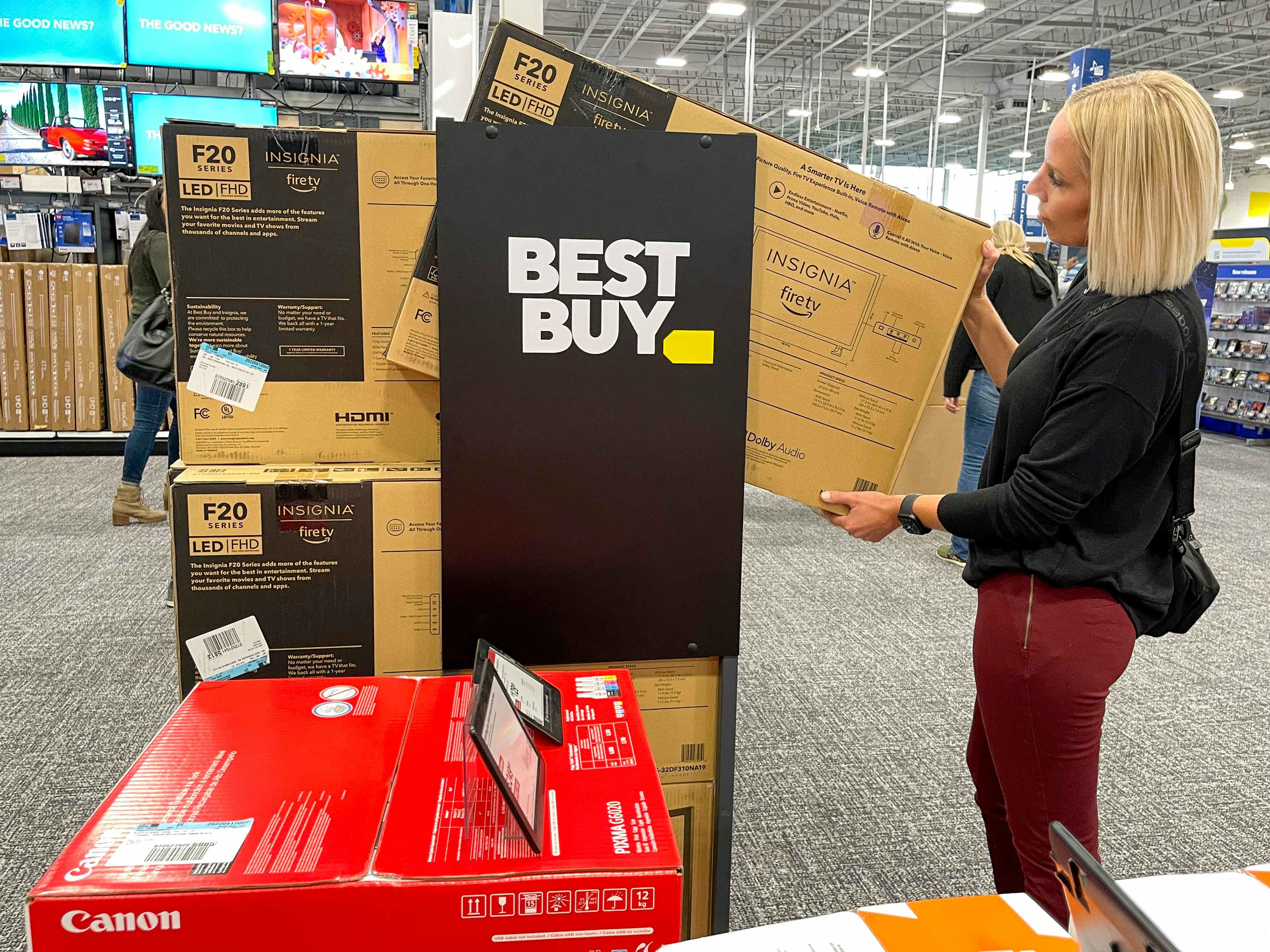 A woman in Best Buy looking at a TV.-kcl-model