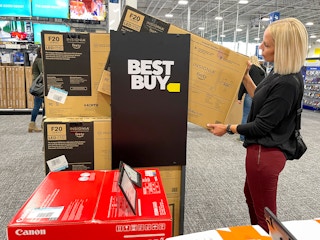 A woman in Best Buy looking at a TV.-kcl-model