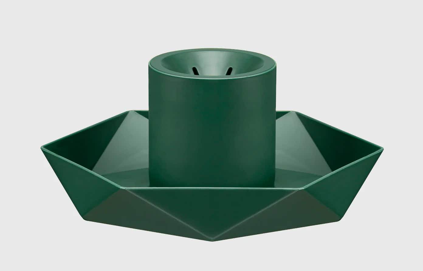 A Green diamond ArtificialChristmas tree stand on a grey background.