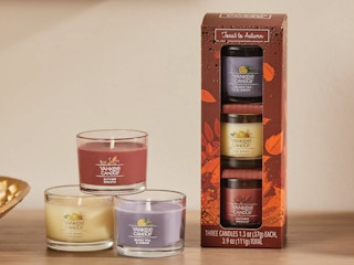 Some fall scented Yankee Candle candles on a table.