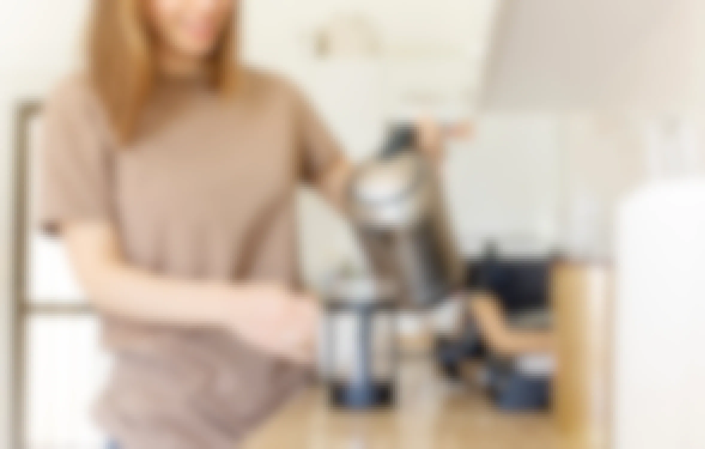woman at home pouring coffee from french press